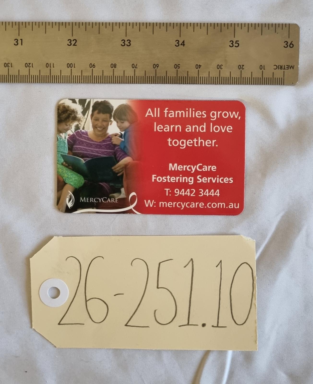 26-251.10 MercyCare Business Card photo with scale and tag.