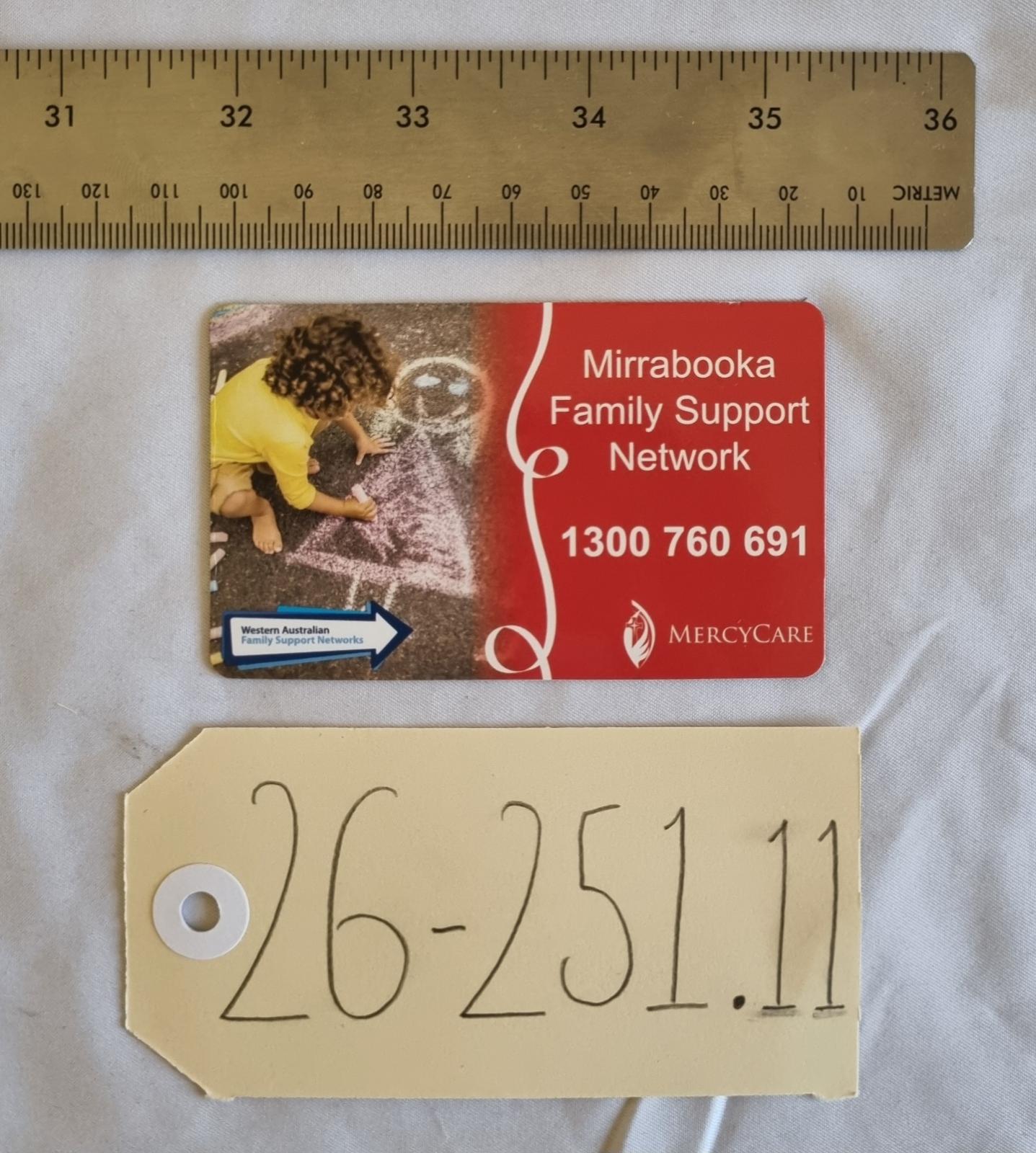 26-251.11 MercyCare Business Card photo with scale and tag.