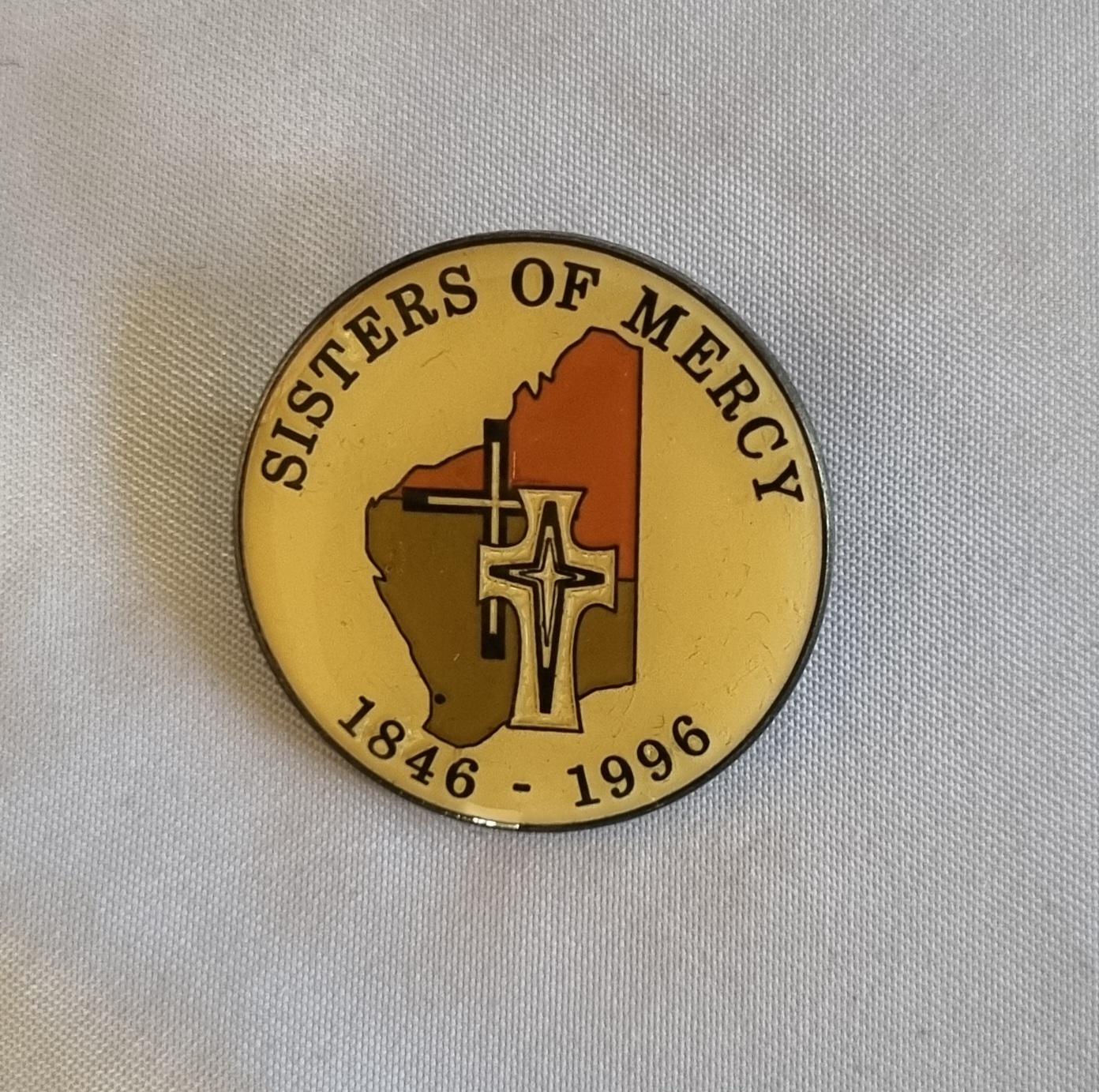 26-253.2 Sisters of Mercy Badge photo with background front-view.