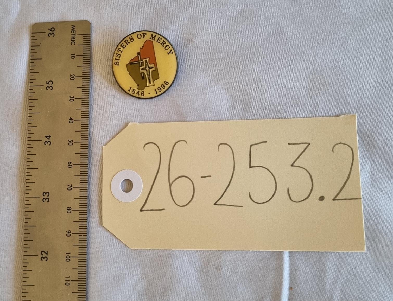 26-253.2 Sisters of Mercy Badge photo with scale and tag. 