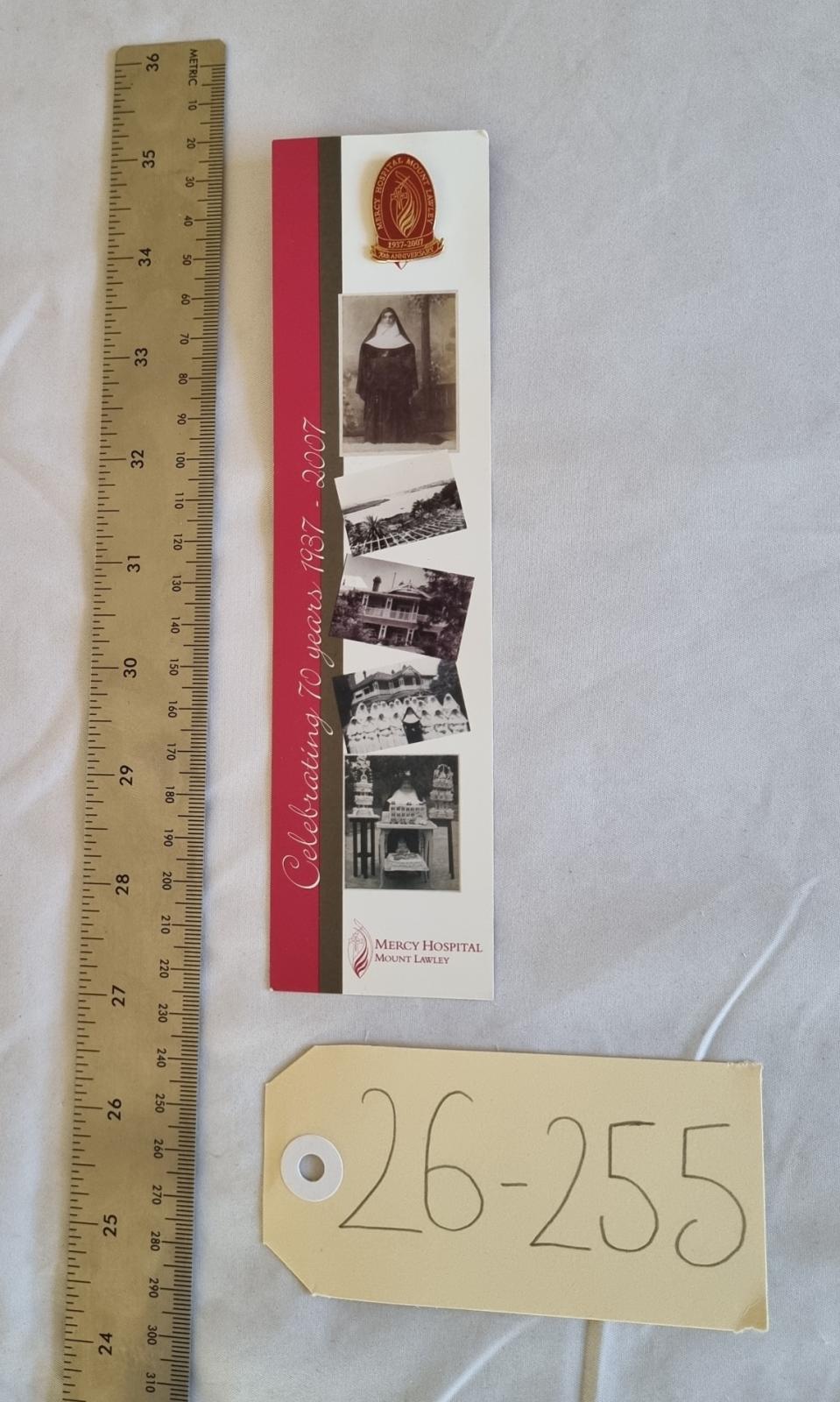 26-255 Mercy Hospital Mount Lawley 70th anniversary badge photo with scale and tag.