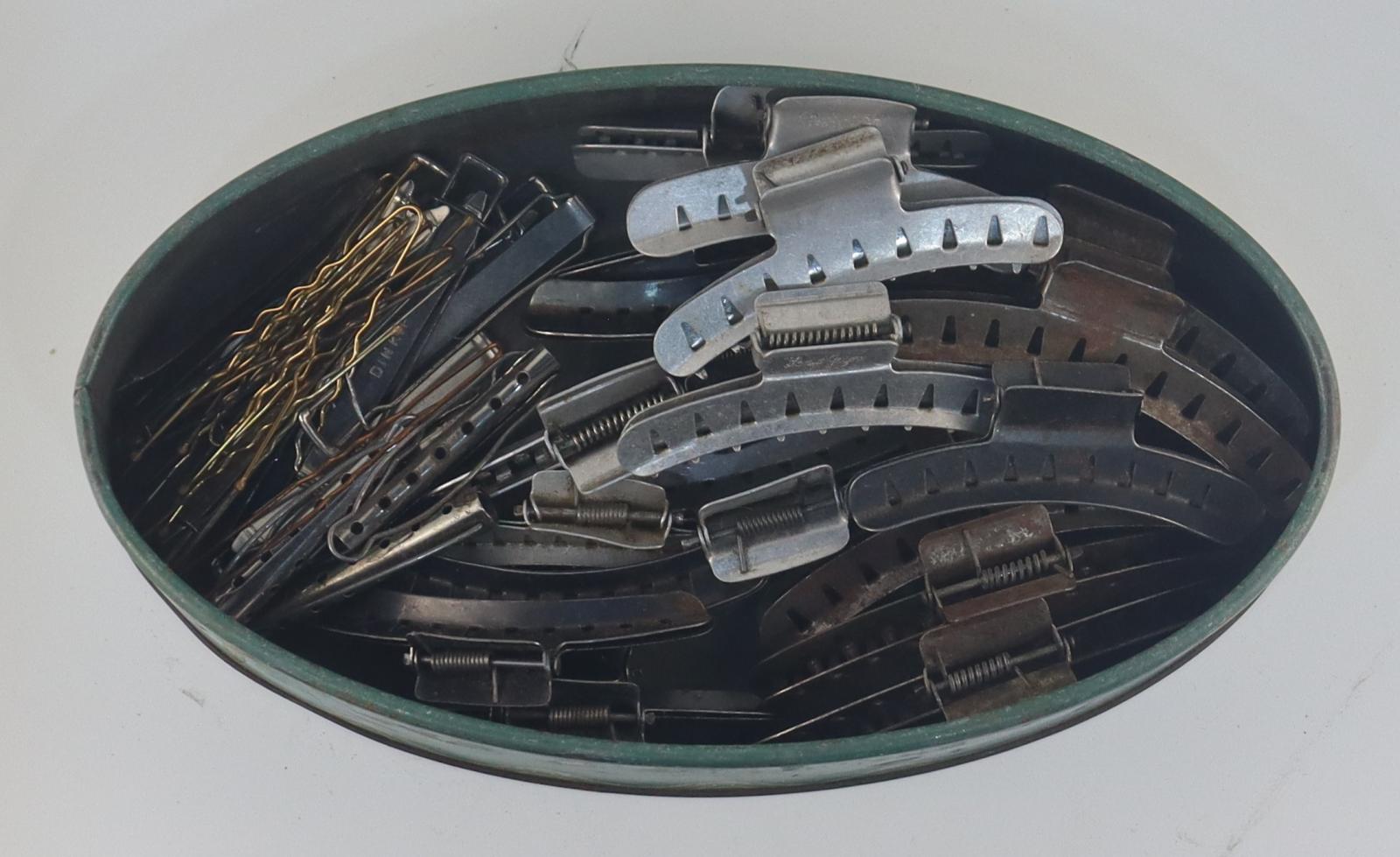 Tin of hair curlers and clips