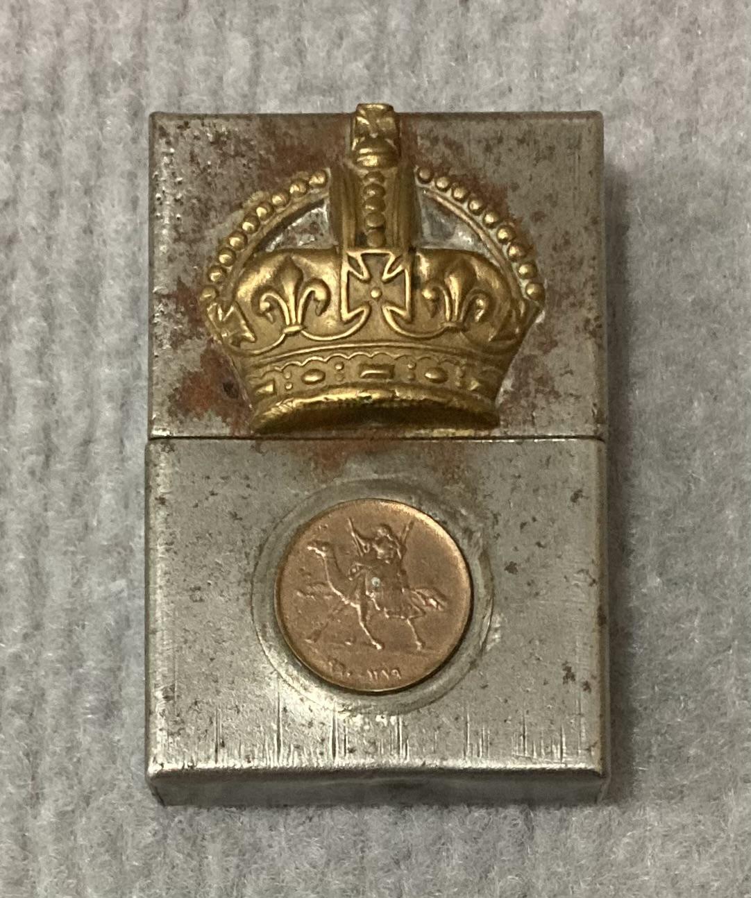 Metal lighter with attached rank badge and coin