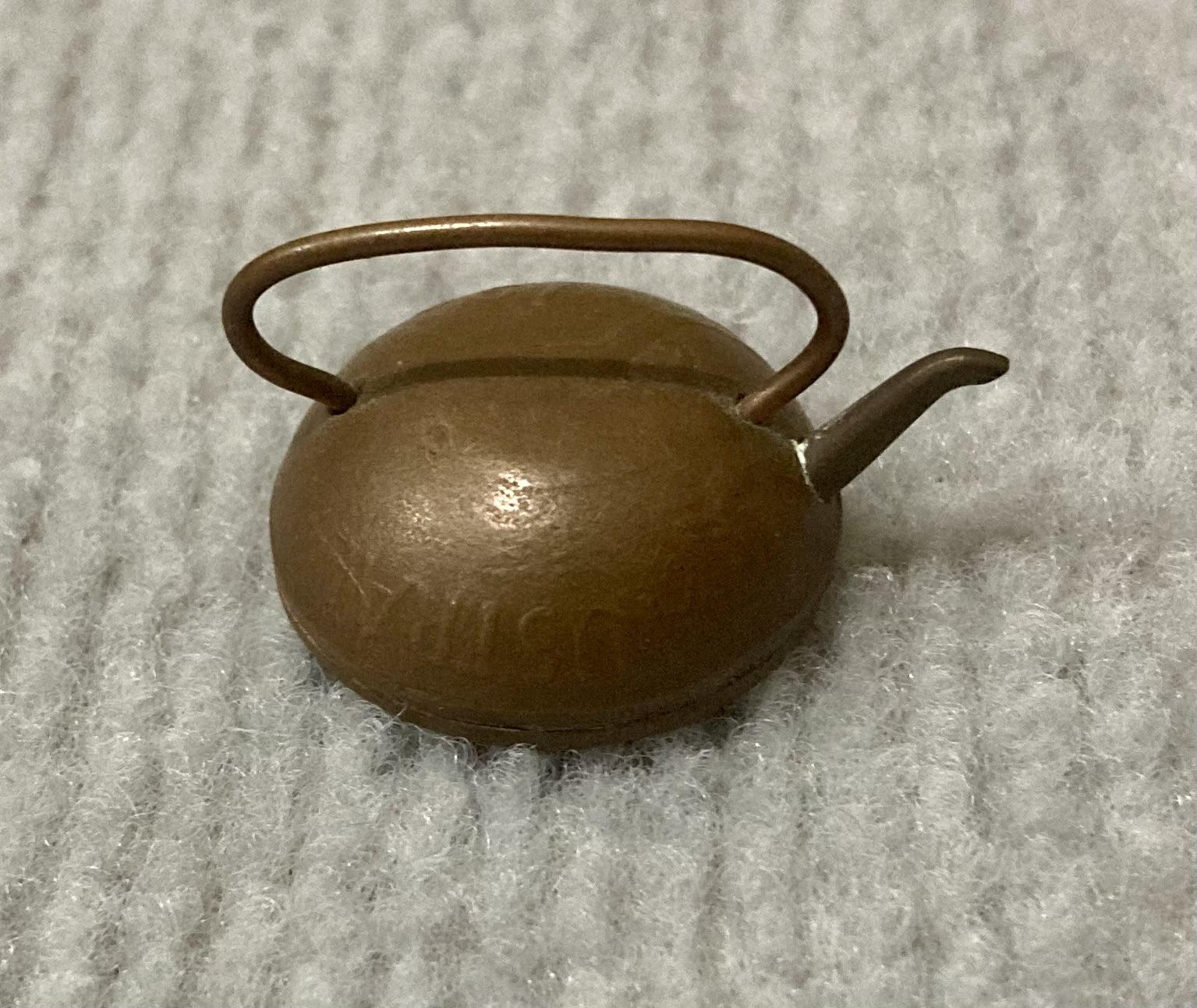 Side view of miniature tea kettle made from Australian coin