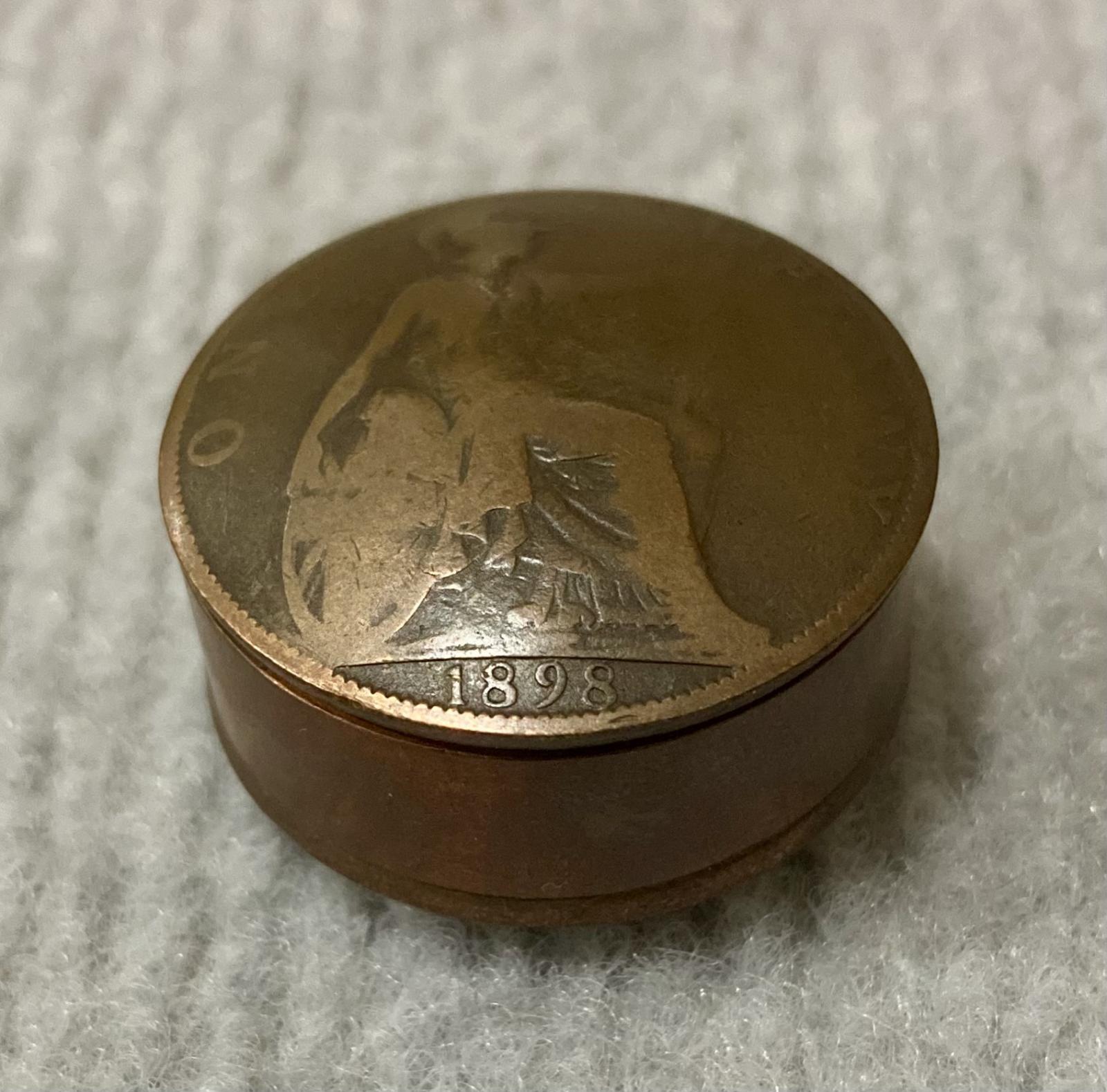 Circular snuff container made from coins