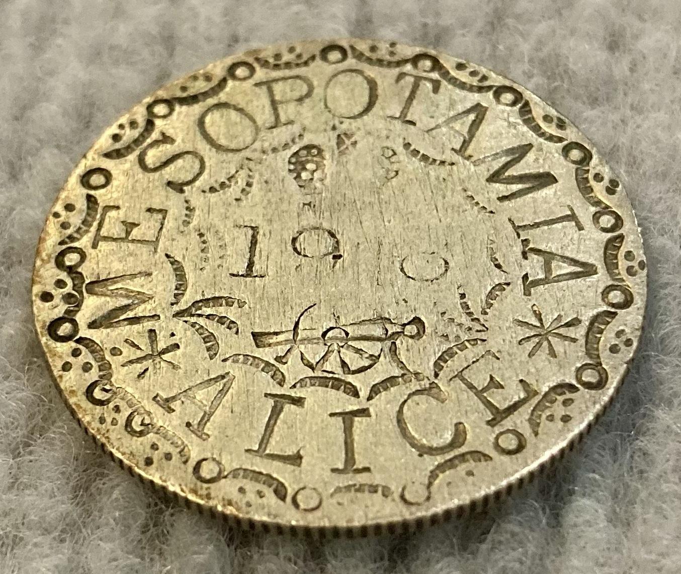 Angled view of love token made from coin sent to Alice from Mesopotamia