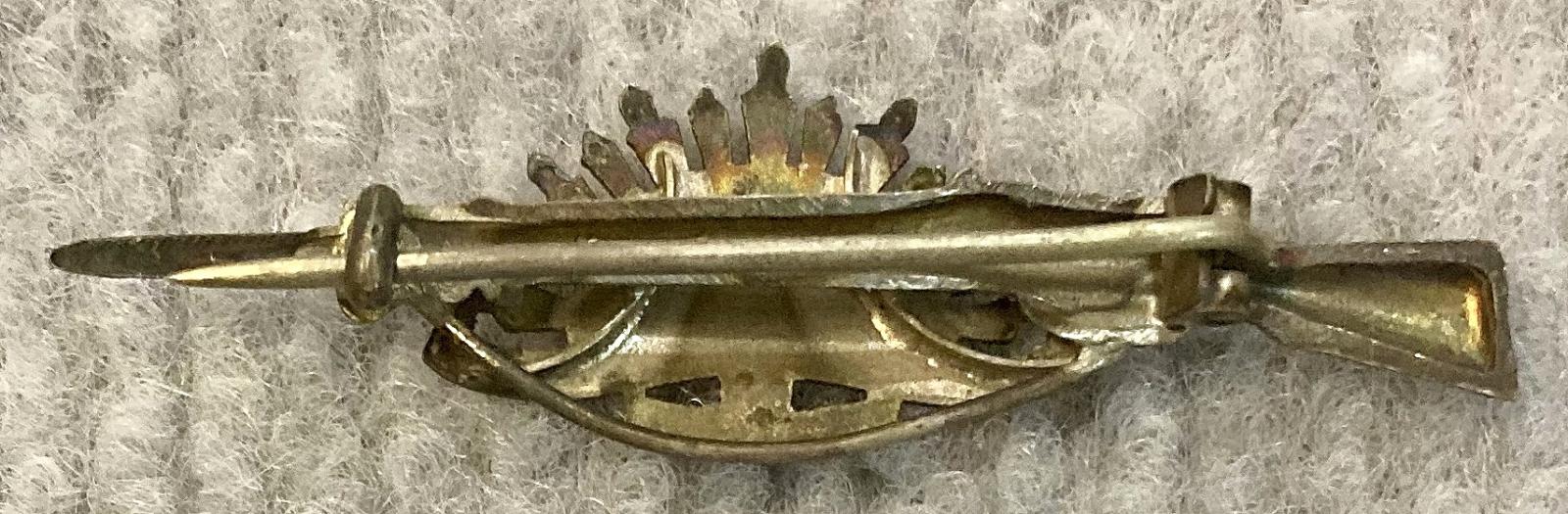 Reverse of sweetheart brooch with Rising Sun badge attached to rifle and bayonet - pin closed