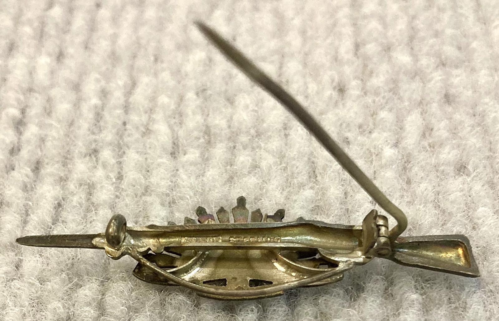 Reverse of sweetheart brooch with Rising Sun badge attached to rifle and bayonet - pin open