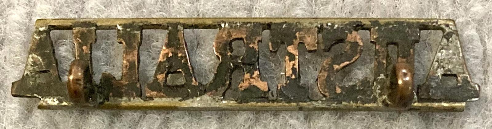 Reverse of straight Australia metal shoulder title