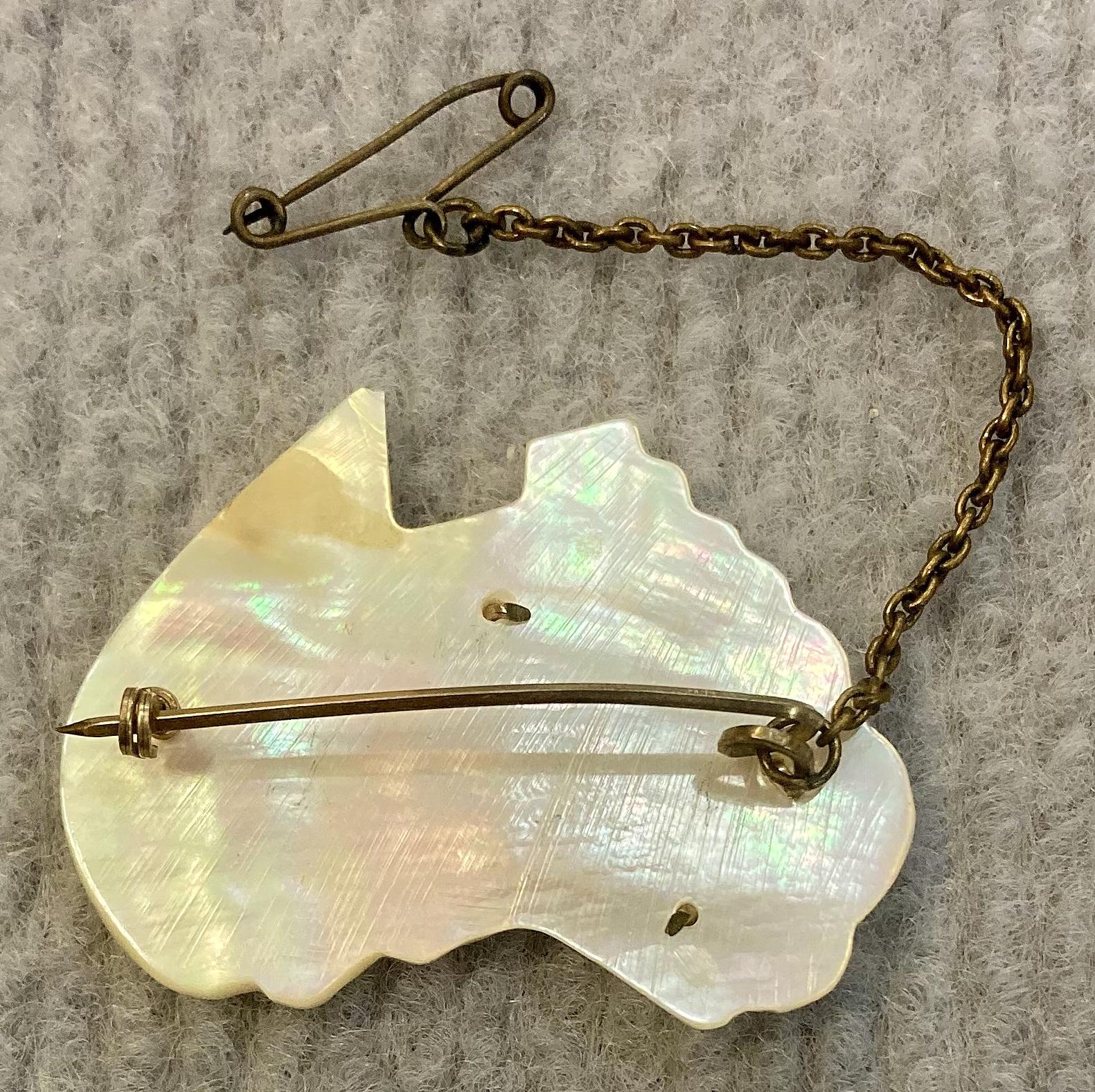 Reverse of mother of pearl A.I.F. sweetheart brooch with attached safety pin