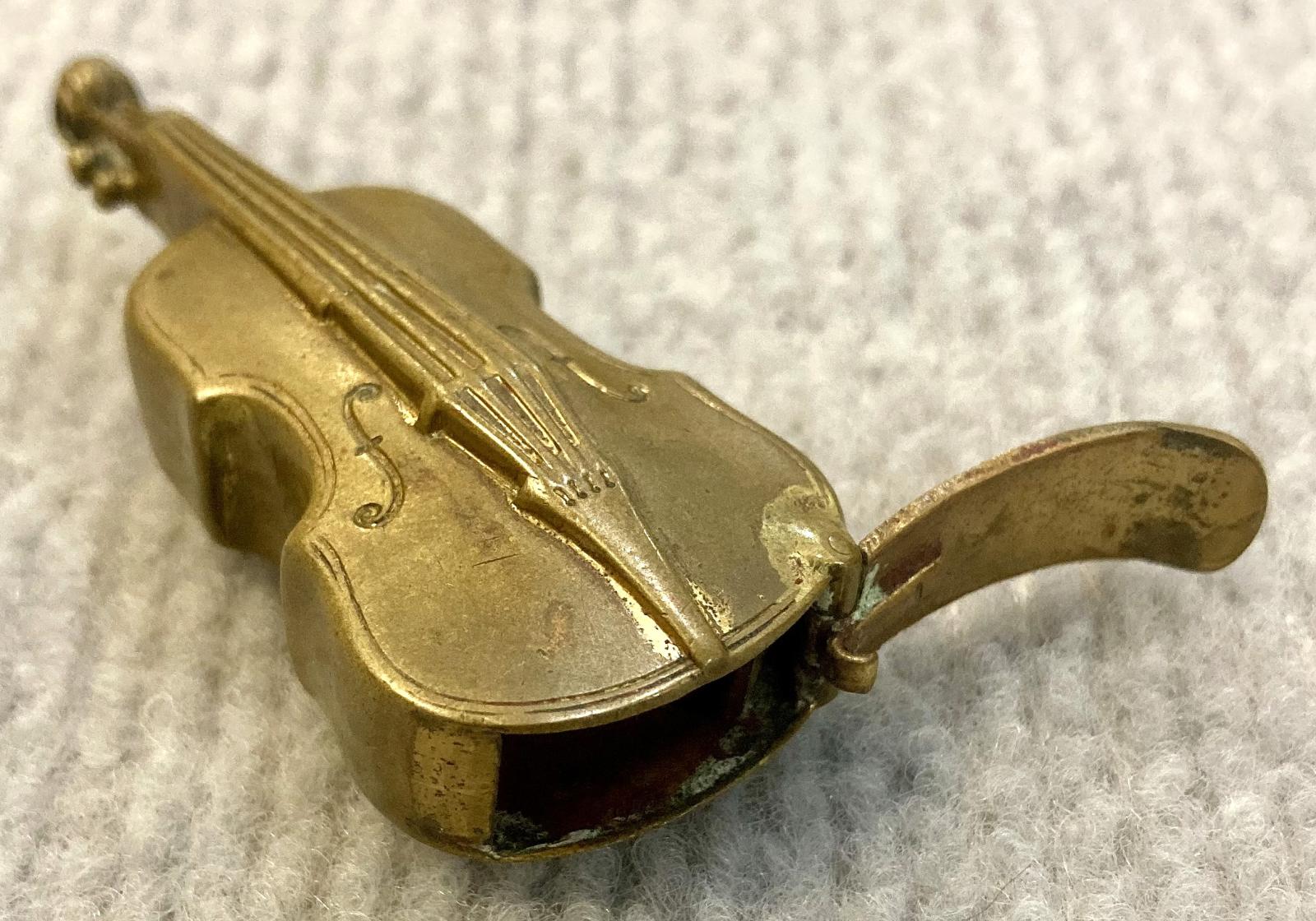 Antique brass vesta case in shape of violin with cover open