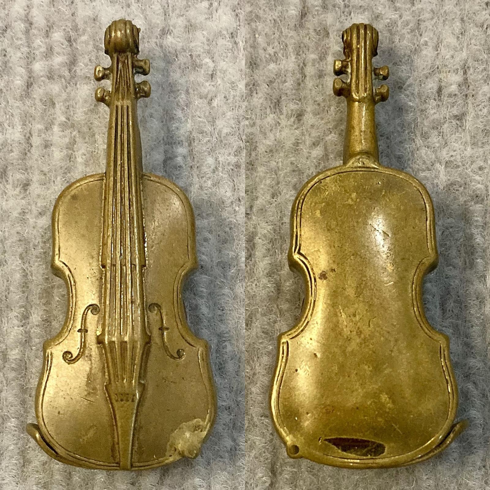 Antique brass vesta case in shape of violin showing front and back