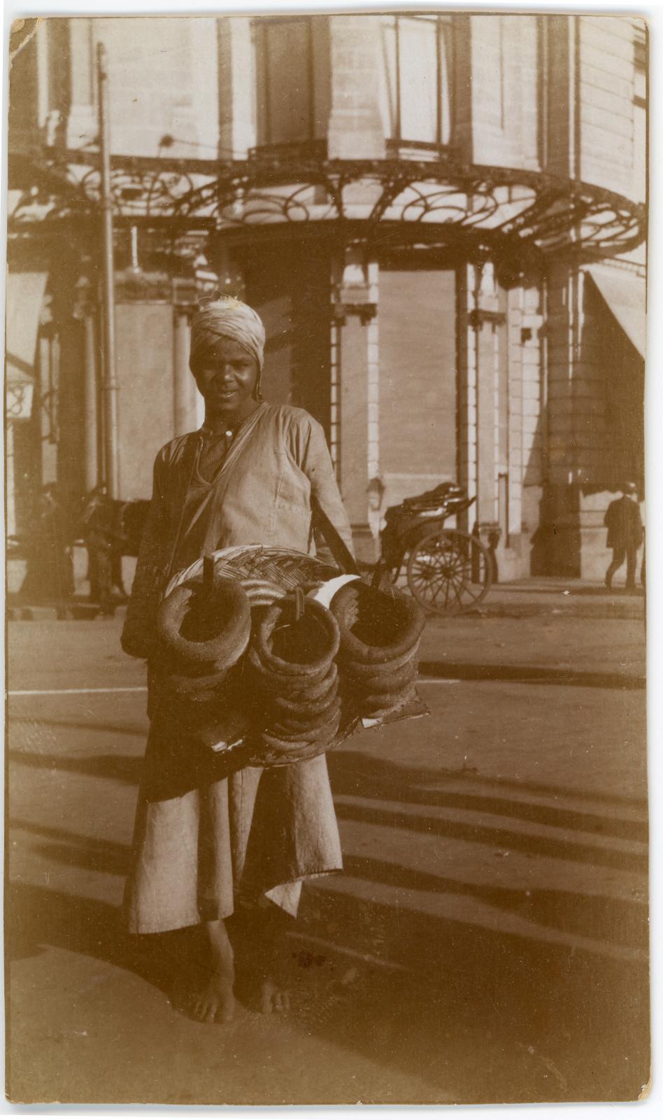 Photo showing young male 'Bread Seller' on a street in Cairo.