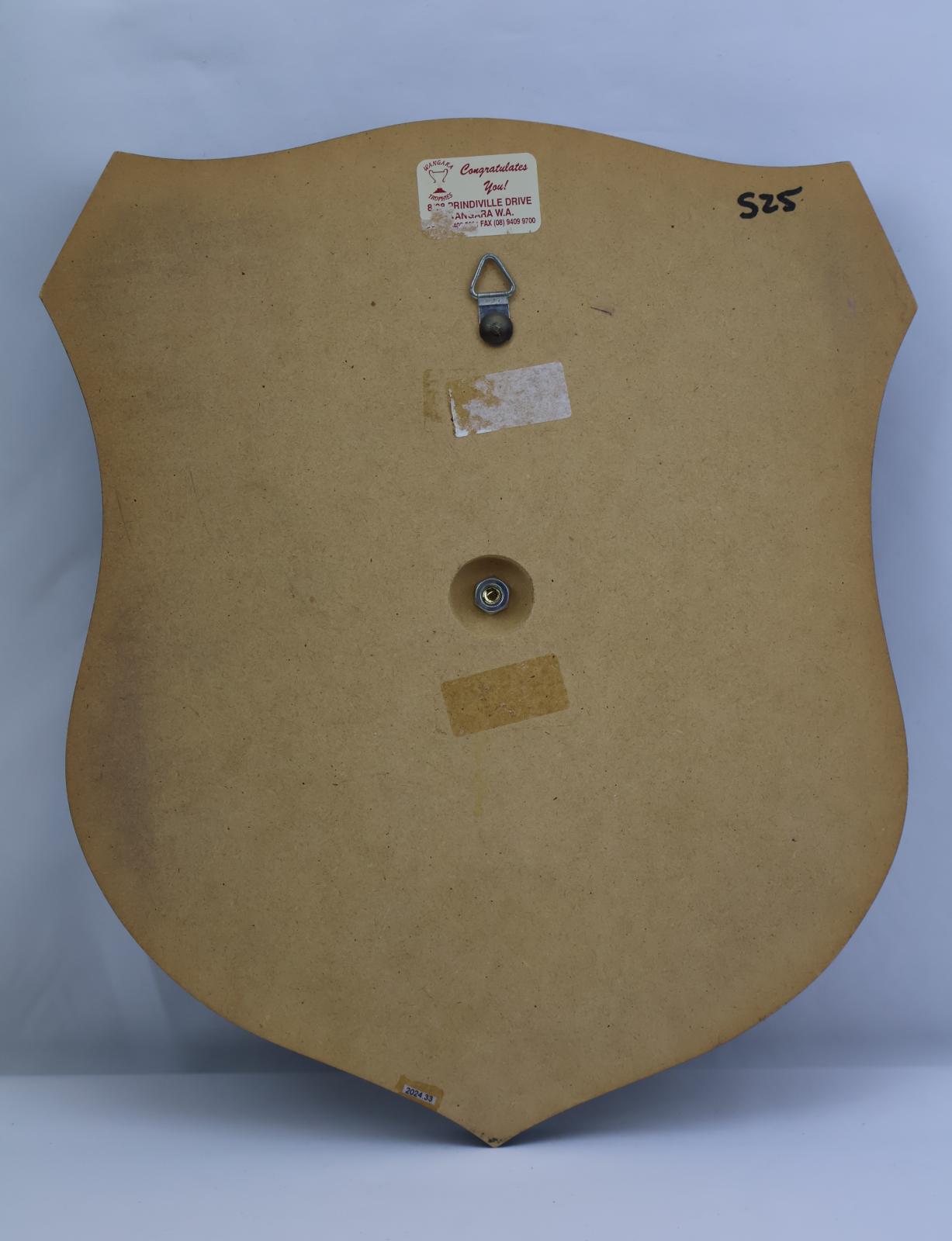 On the back is a small round hole with a white sticker with blue writing above.