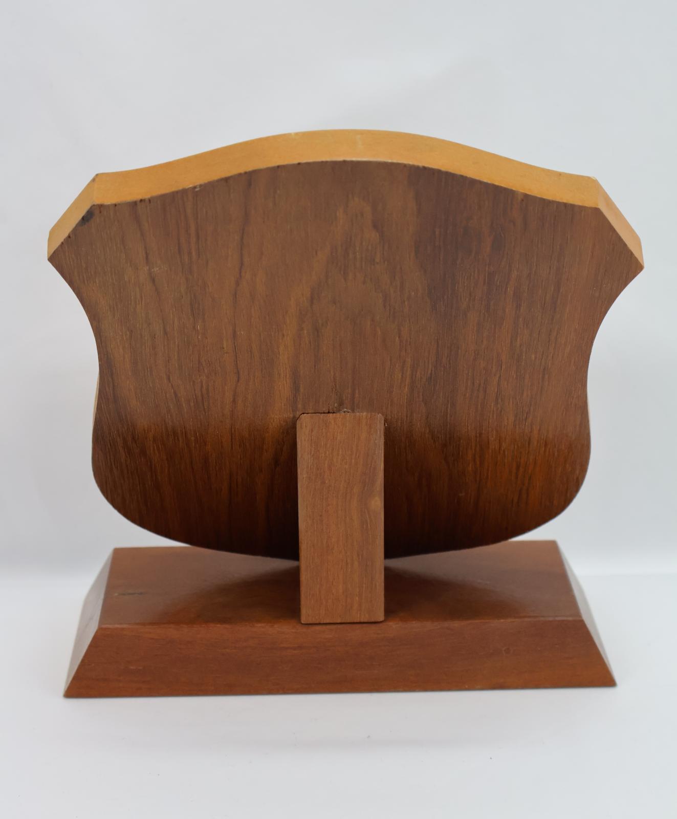 The reverse of the shield where you can see the base and the rectangular piece that holds up the shield.
