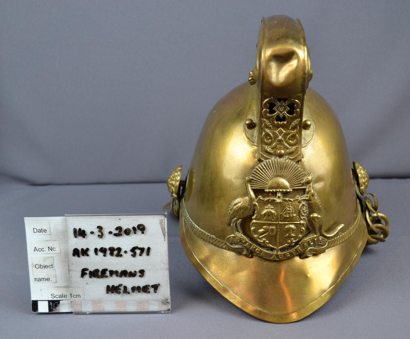 Brass helm with Coat of arms with rising sun.