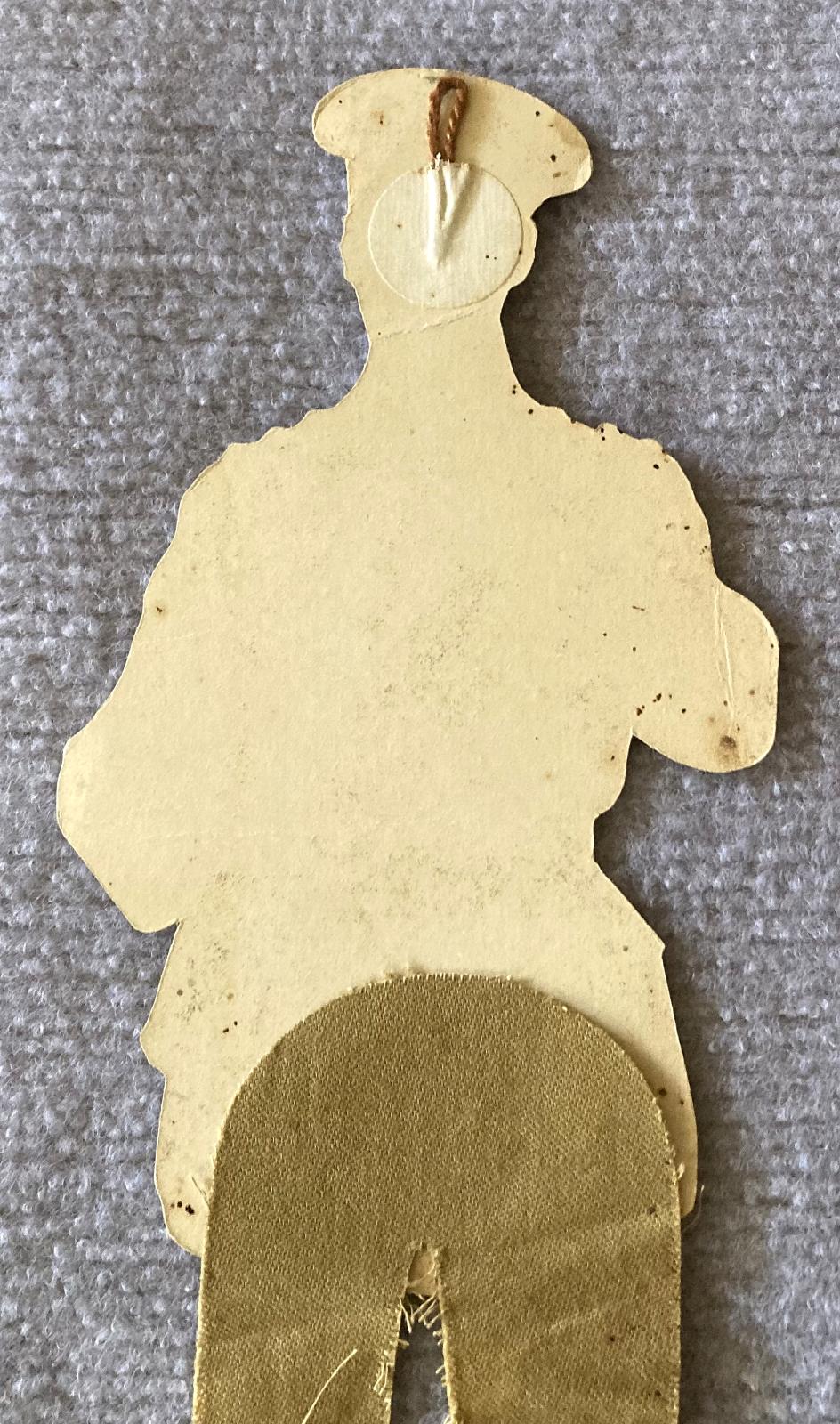 Close-up of top half of reverse of WWI era paper doll of British Army Officer 