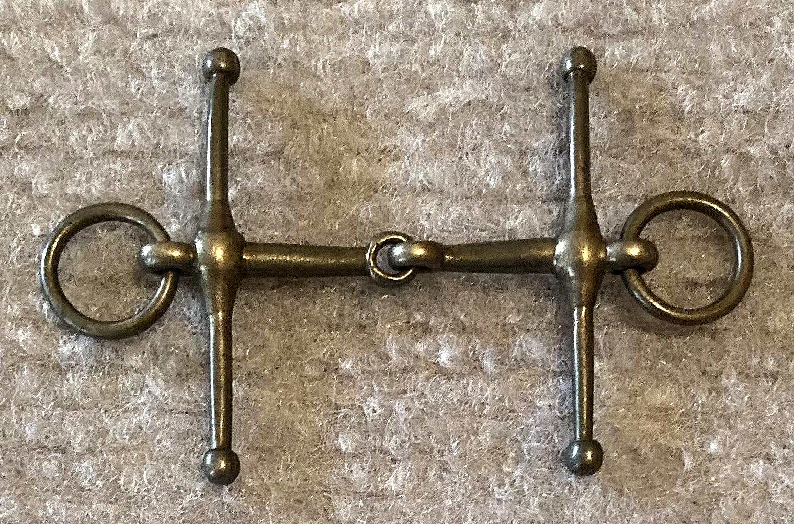 Other side of miniature metal full cheek, loose ring, snaffle horse bridle bit