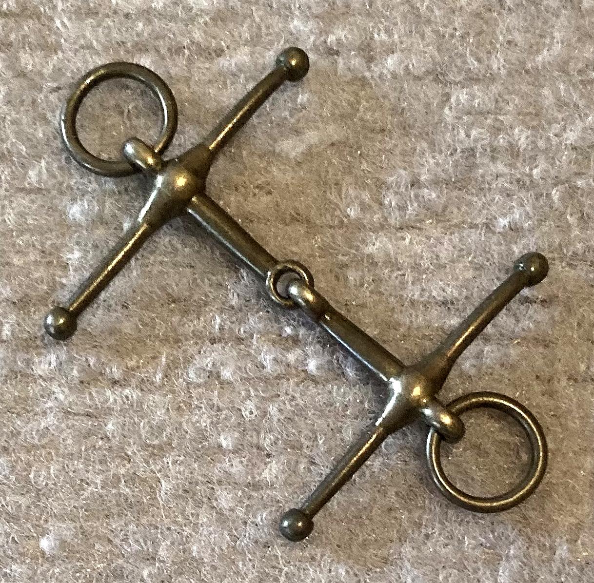 Other angled view of miniature metal full cheek, loose ring, snaffle horse bridle bit