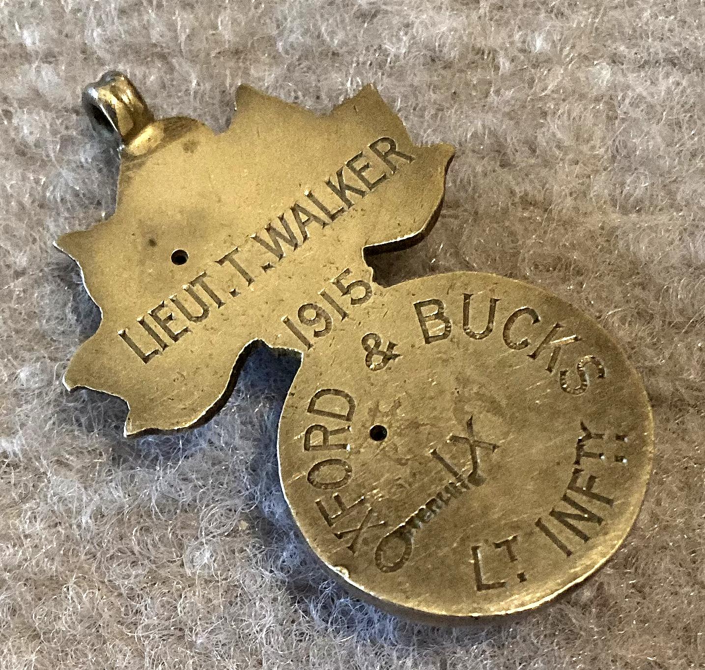 Angled view of sterling silver pendant or fob named to Lieutenant T. Walker, 1915