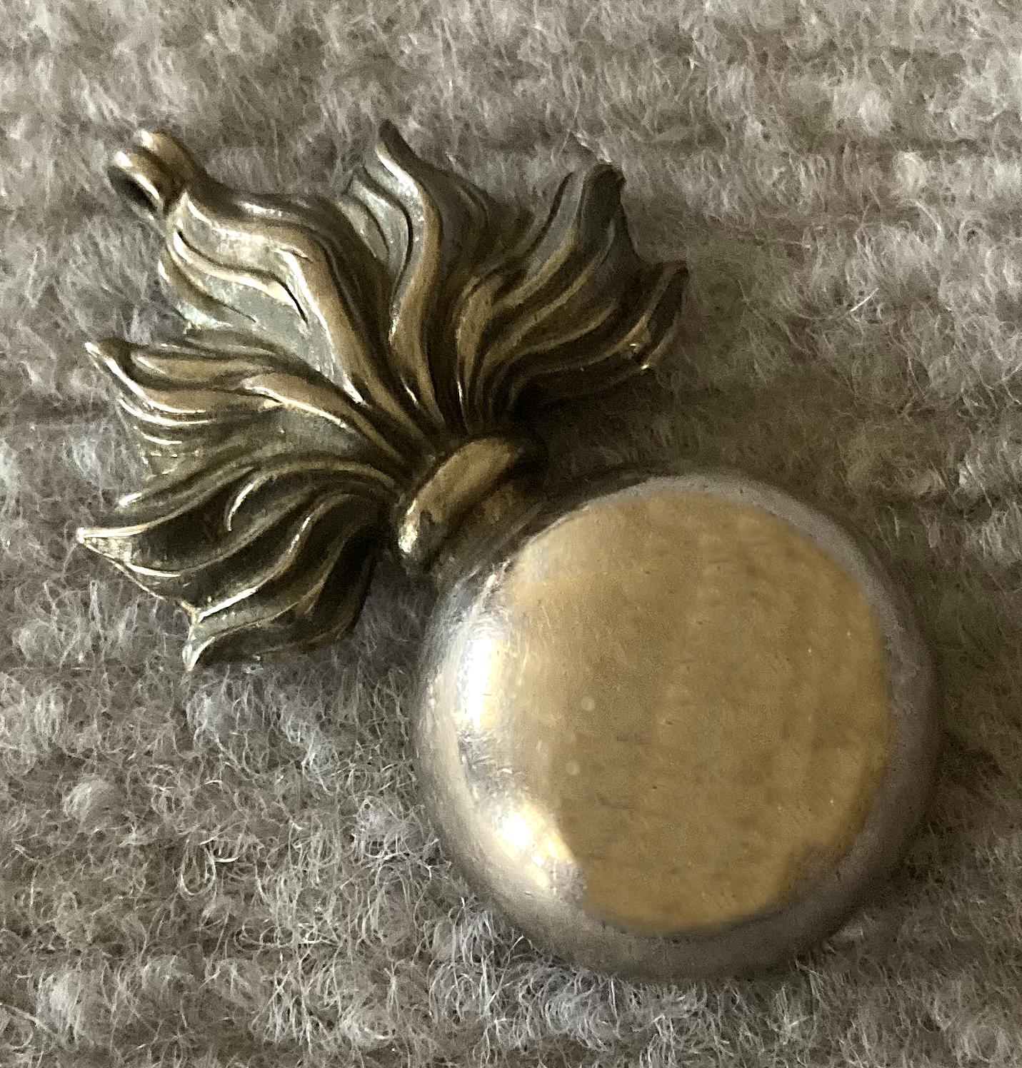 Angled view of reverse of sterling silver pendant or fob named to Lieutenant T. Walker, 1915