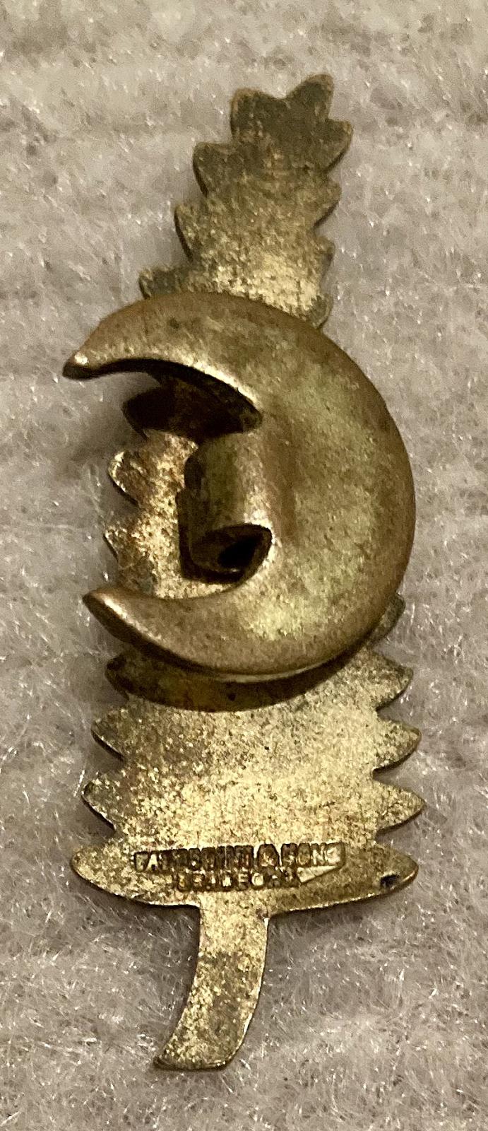 Reverse of 1921 New Zealand silver fern sweetheart brooch showing maker's name
