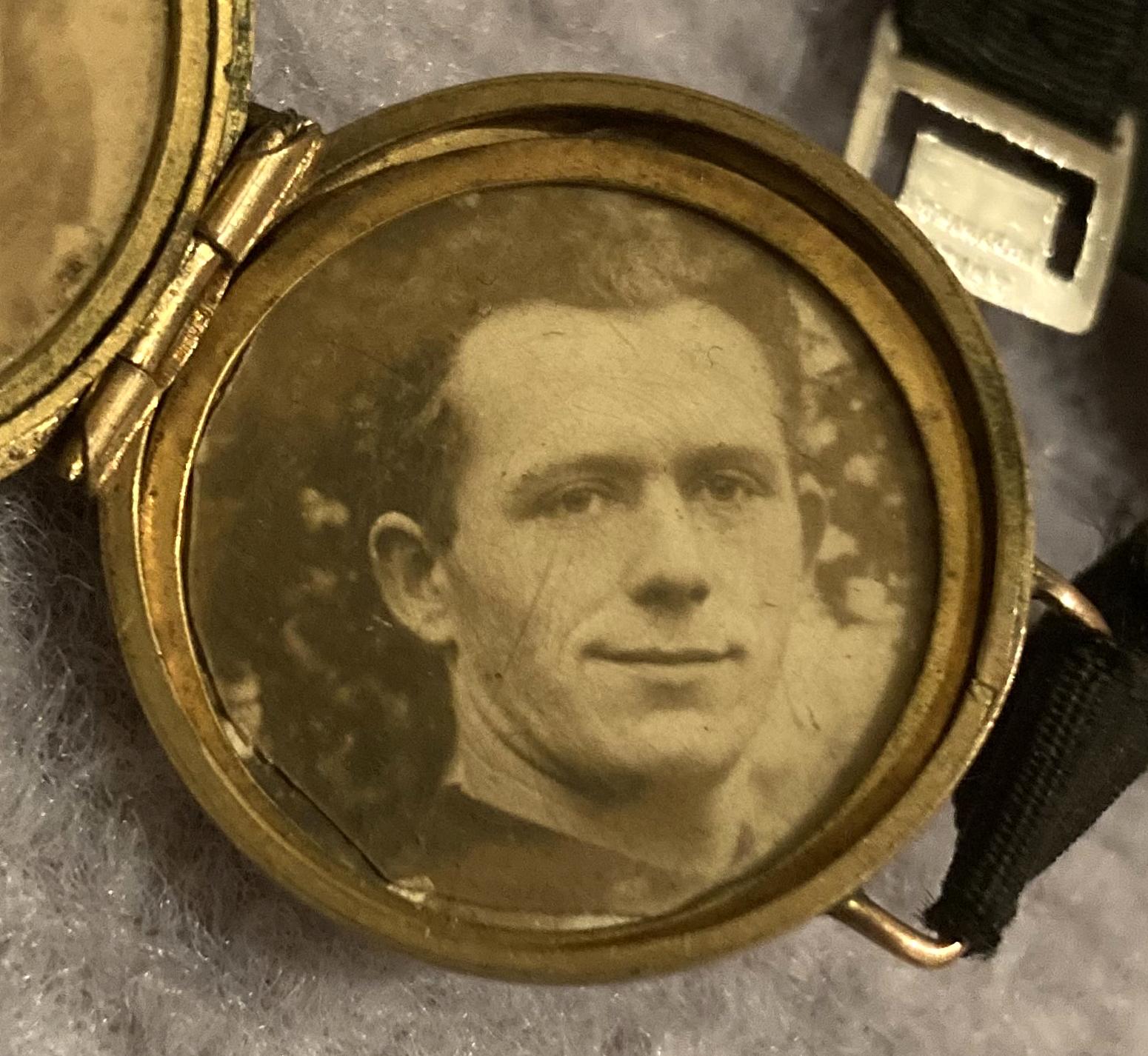 Close-up of Birmingham Battalion lapel badge converted to photo locket showing man