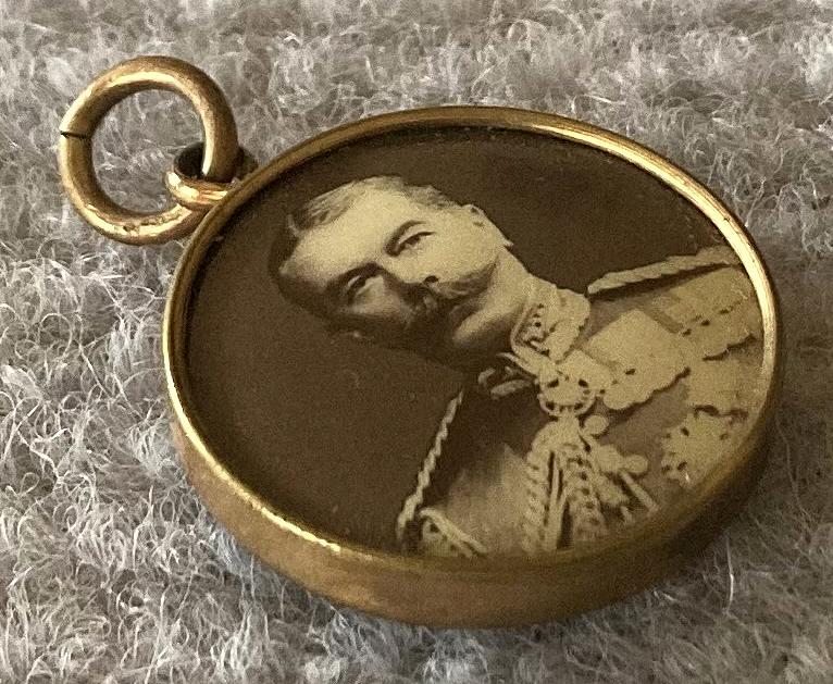 Angled view of World War One era double-sided photographic pendant - Lord Kitchener