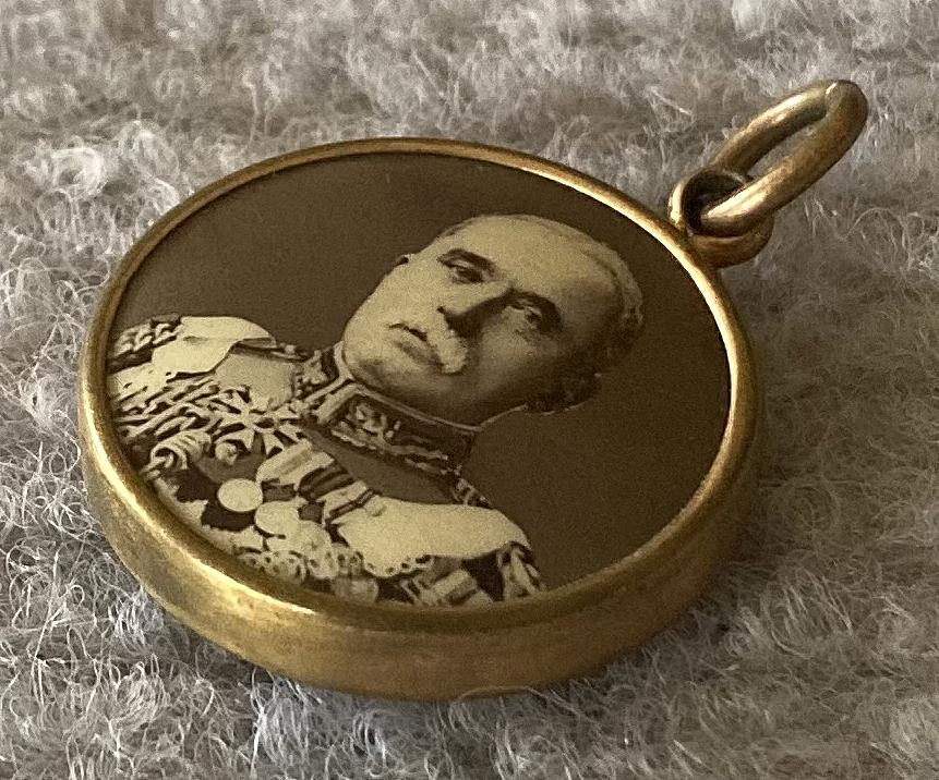 Angled view of World War One era double-sided photographic pendant - General French
