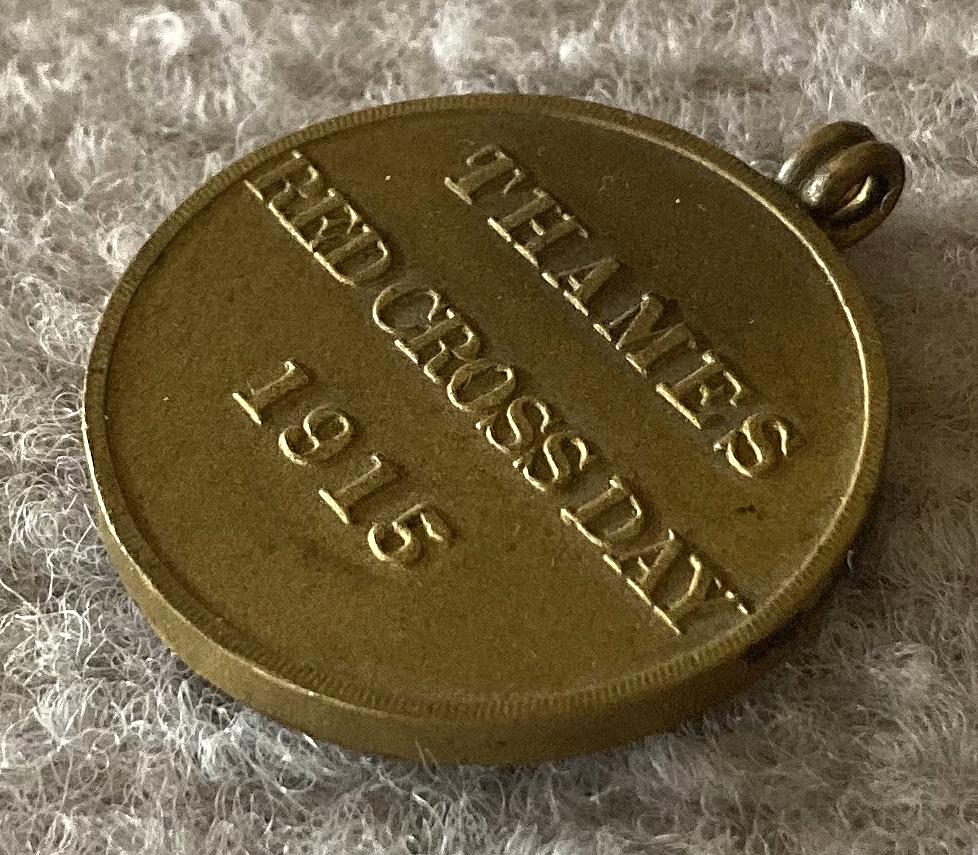 Angled view of fundraising medallion sold to support Thames Red Cross Day - 1915