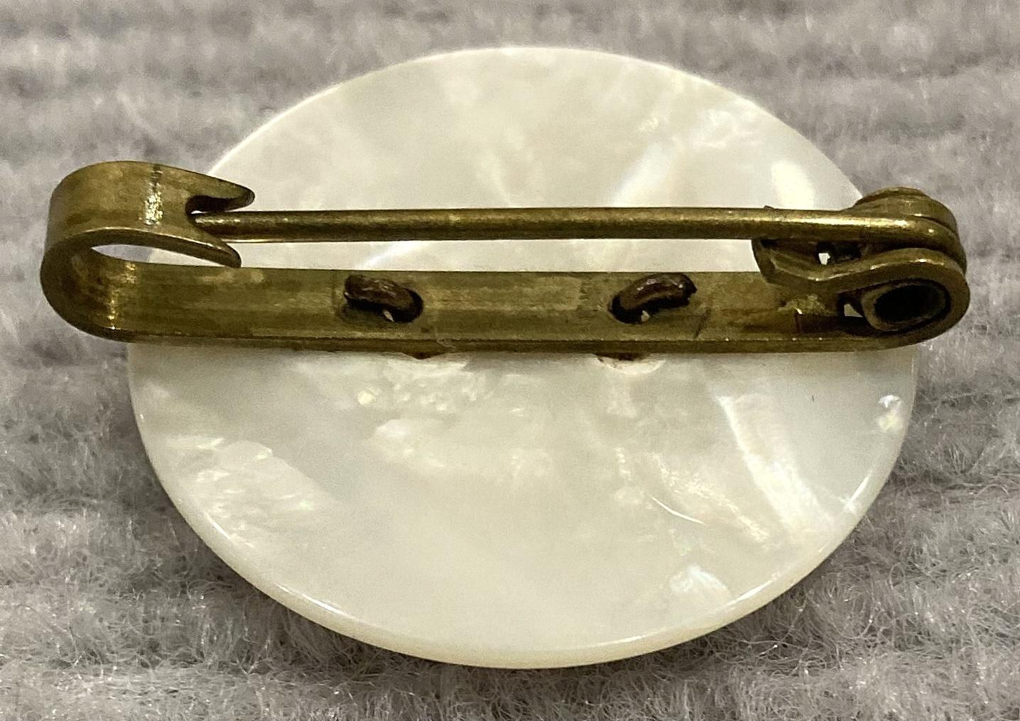 Oblique view of reverse of King's Royal Rifle Company mother of pearl sweetheart brooch