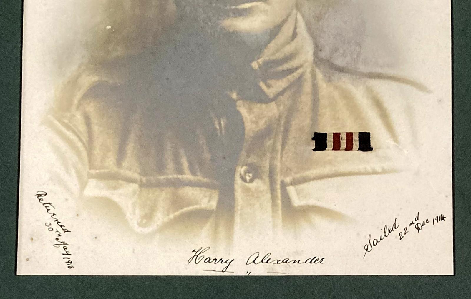 Close-up of writing and medal ribbon on portrait of Harry Alexander M.M.