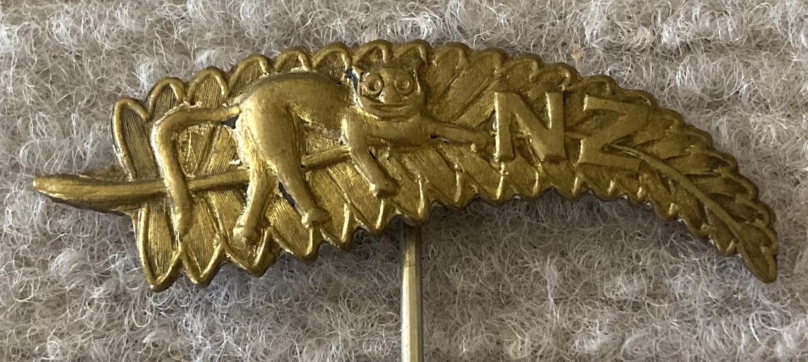 Close-up of WWI era NZ silver fern sweetheart pin with 'cat' motif