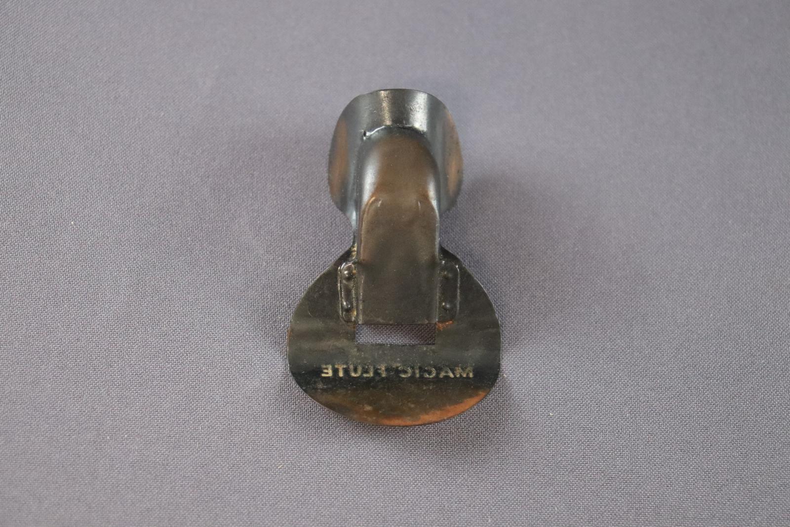 A small, metal nose-flute.