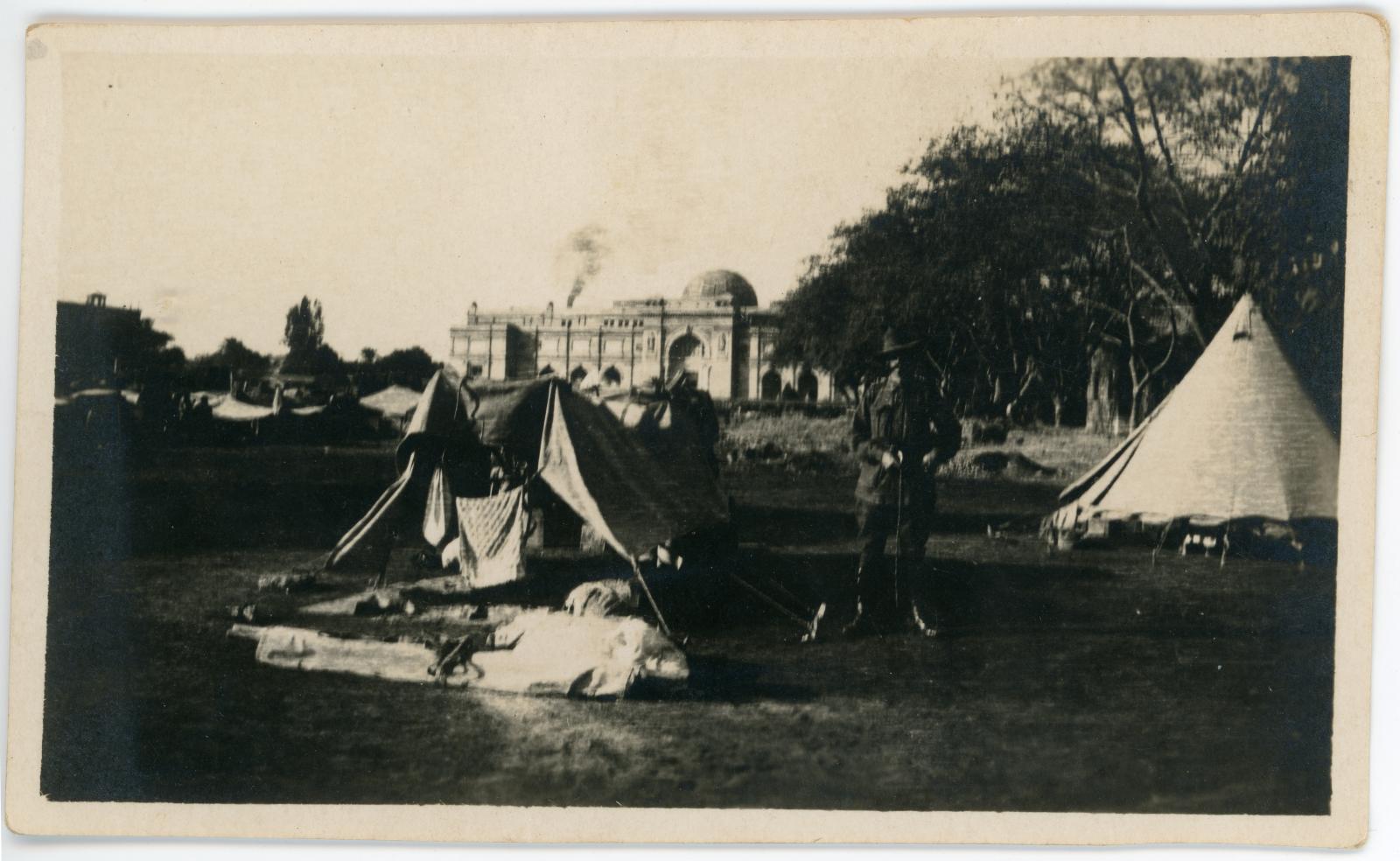 Photo of the grounds at Kasr-el-Nil Barracks, with Australian soldier standing outside a tent.