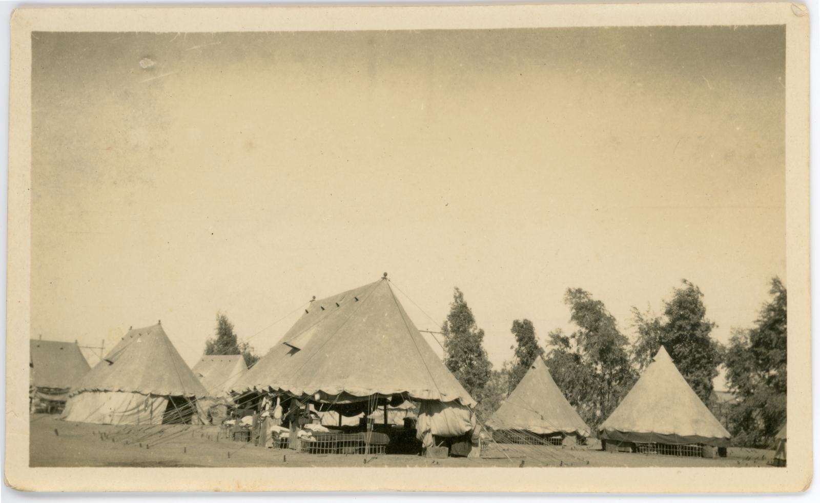 Photo showing tents of a military camp. 