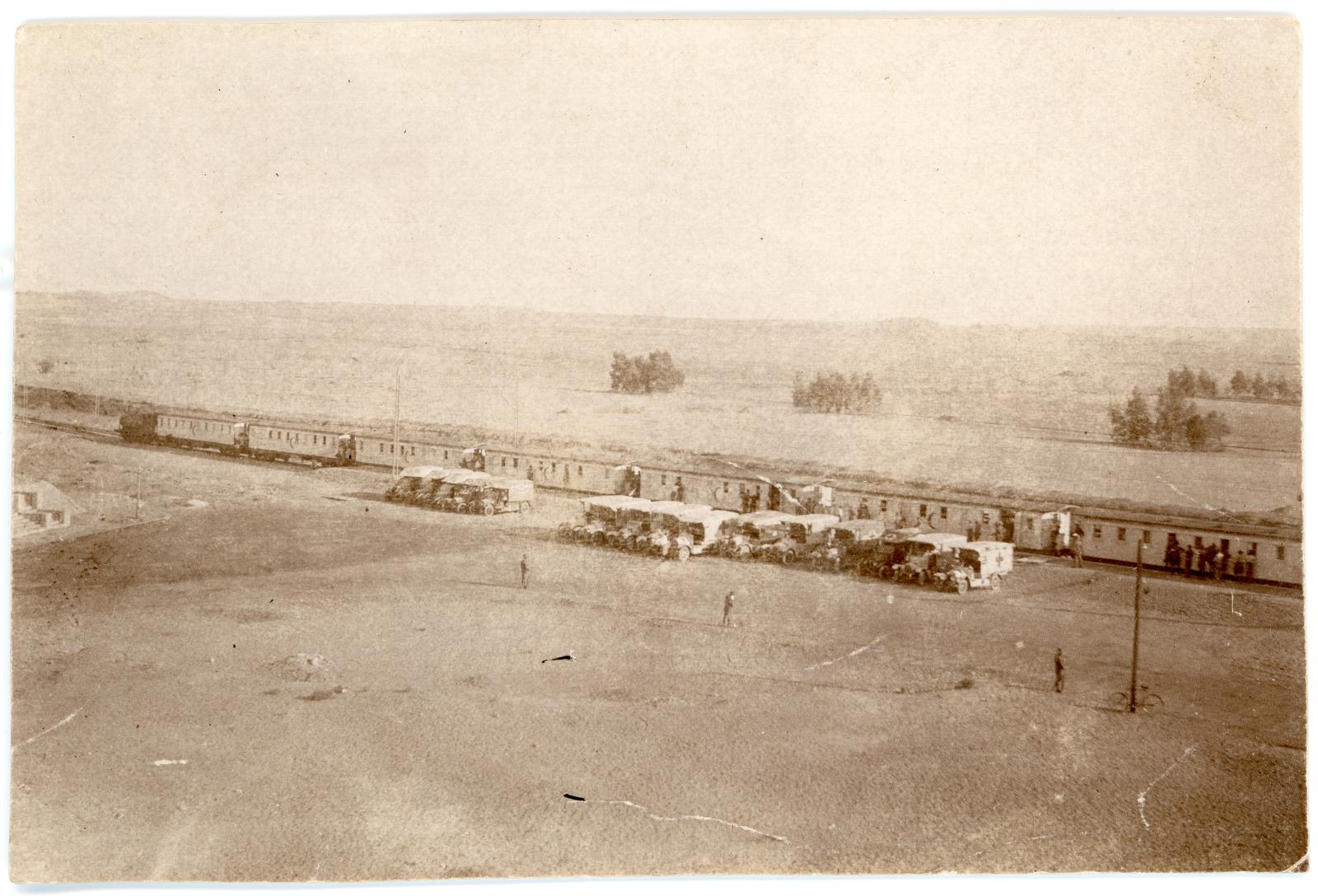 Photo showing waiting Australian ambulance waiting for wounded to be unloaded from hospital train. 