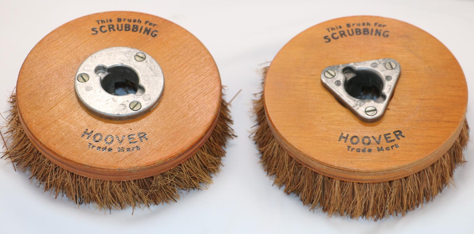Hard bristled scrubbing brush. Circular wooden base with bristles attached to the bottom. Triangular metal plate in the centre to attach to machine. "This brush for scrubbing" printed along the top in black and "Hoover Trade Mark" printed along the bottom.
