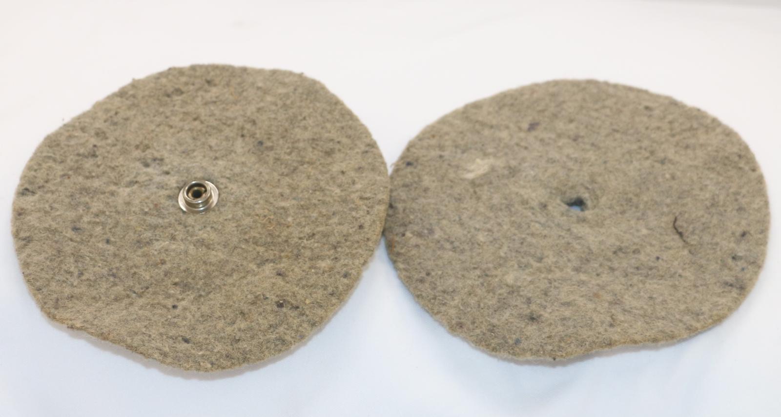 Khaki coloured, circular piece of felt with small hole in the centre.