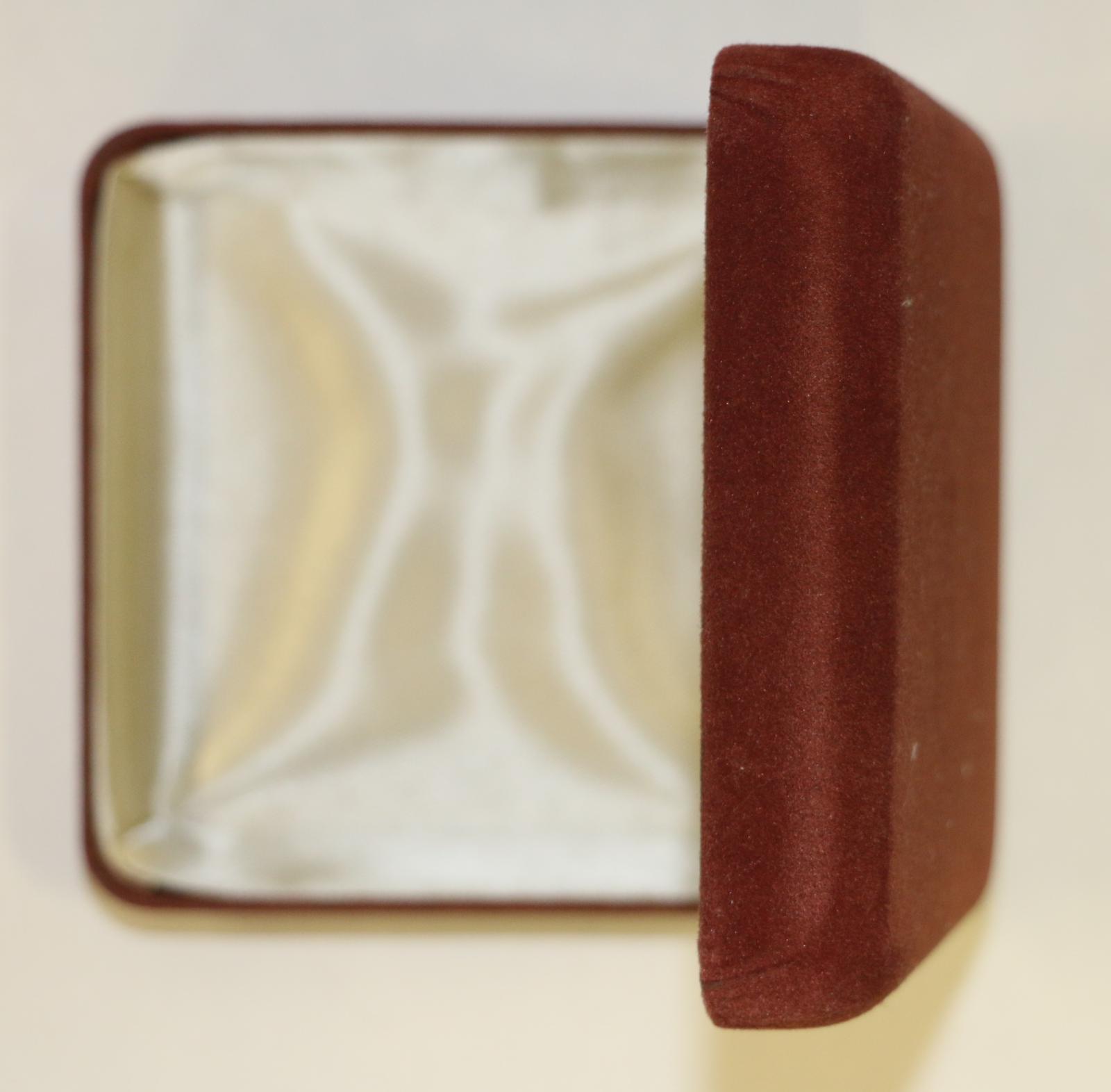 Burgundy velvet case, the inside is lined with a cream lining fabric. "With Compliments/ MAYOR and COUNCILLORS/ CITY of WANNEROO" written on the inside of the lid. Lid lining on RHS and bottom has come away from the edges, also starting to come away from the edge at LHS bottom corner.
