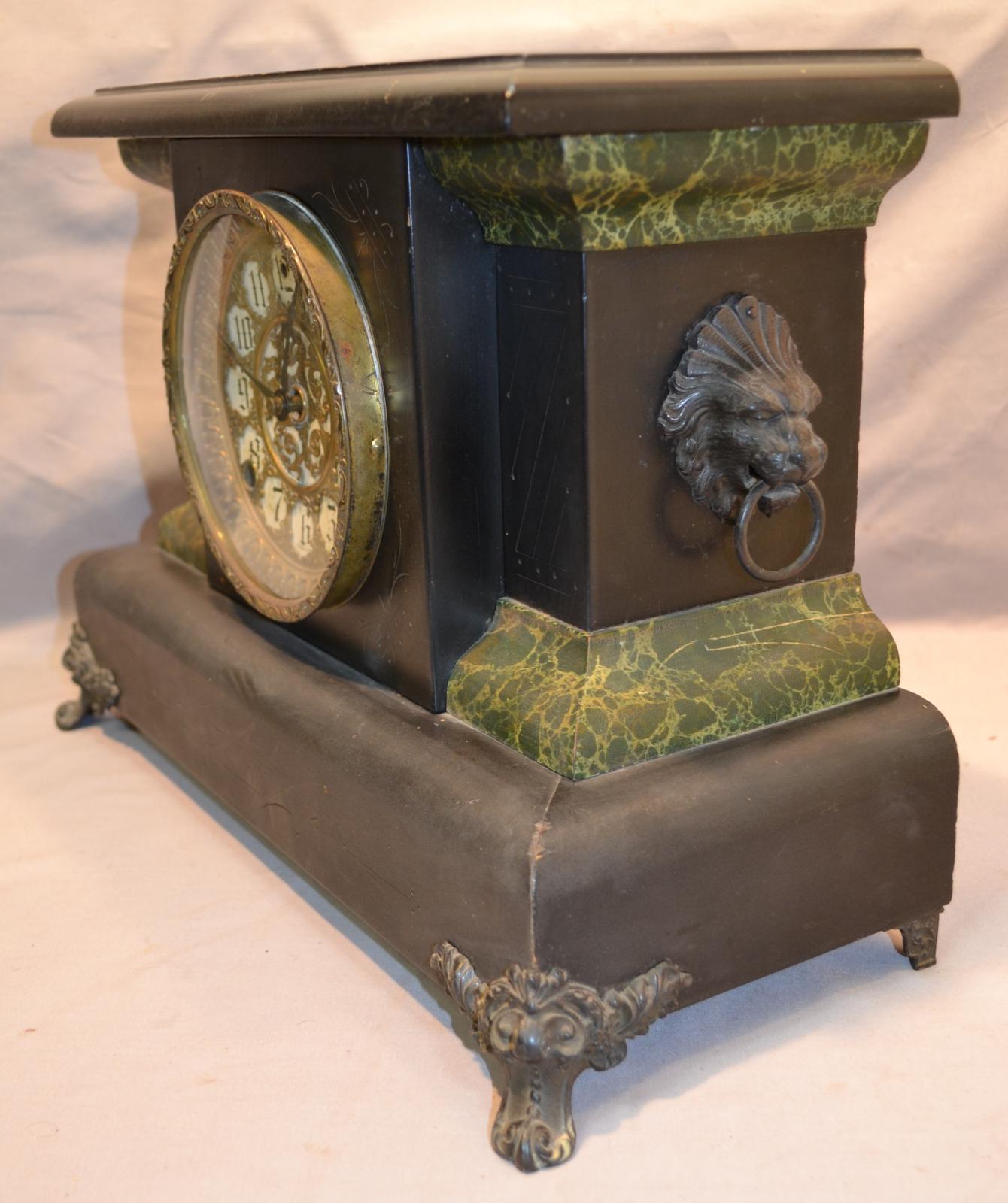 A rectangular mantle clock, finished with black lacquer and gilded gold-coloured metal.