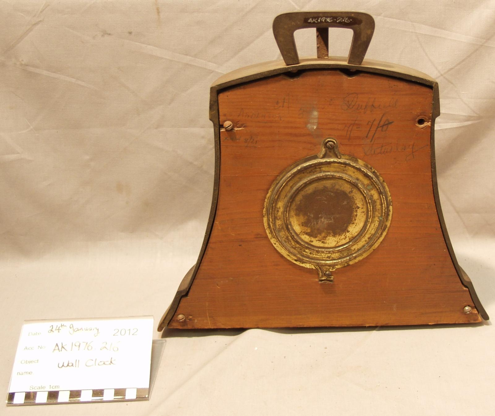 The back side of a a mantle clock made from a ship's bell.
