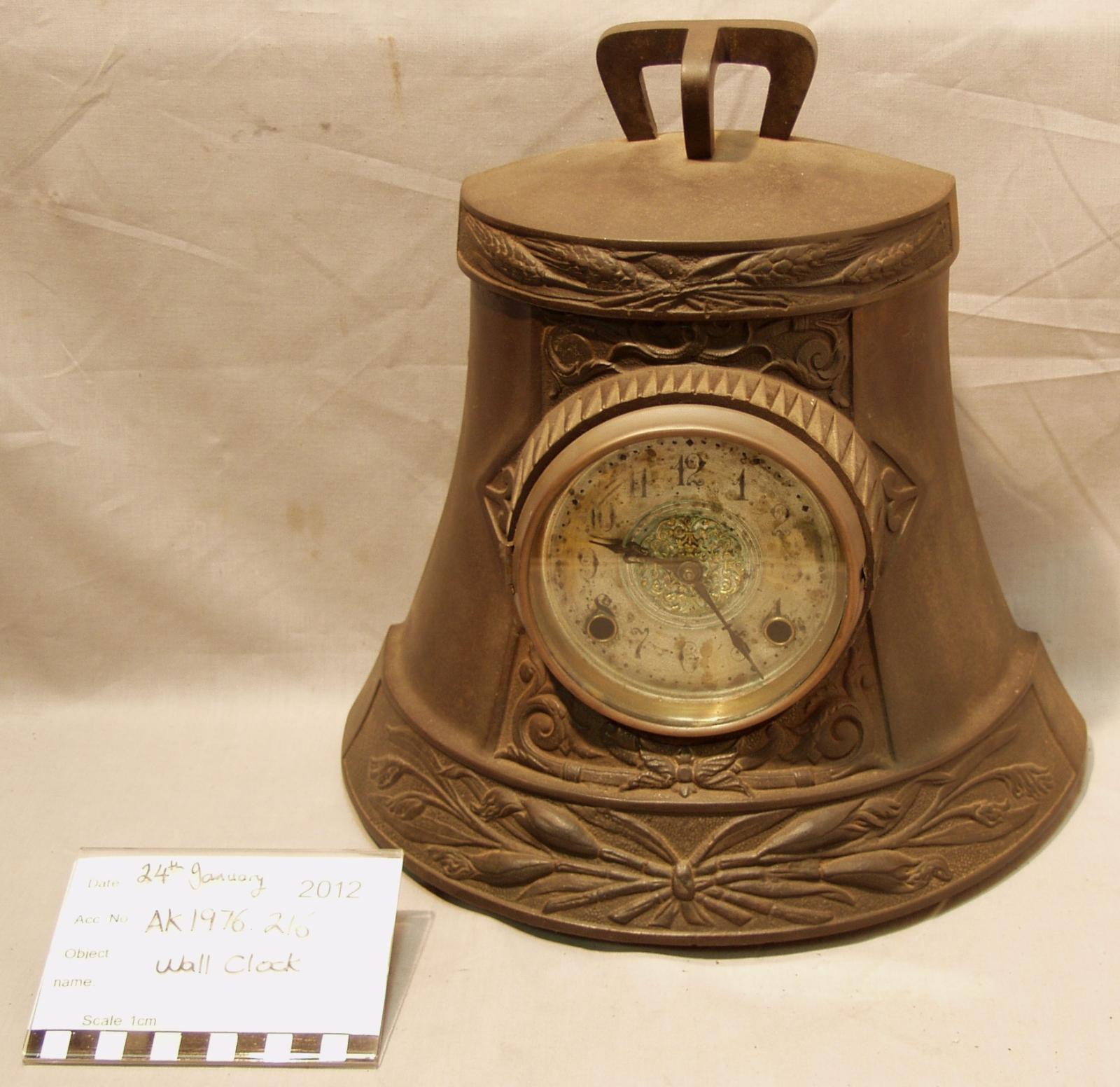 The front of a clock made from half a brass ship's bell.