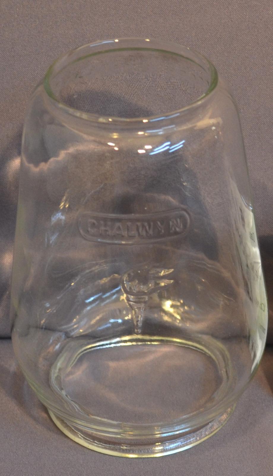 Lamp Globe (Glass), cylindrical, open at both ends and tapering towards the top which ends in a lip, with text reading "CHALWYN" across the middle of the globe.
