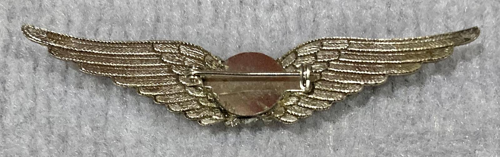 Reverse of Silver tone sweetheart brooch featuring wings with central heart and pink stones