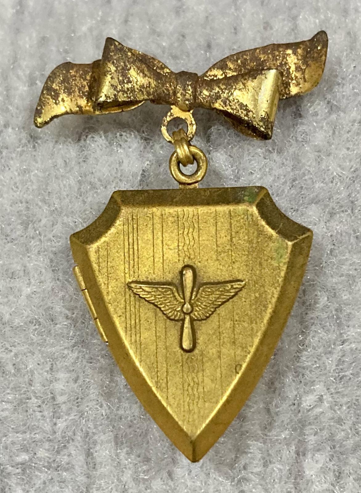 United States Army Air Force gold tone locket suspended from bow