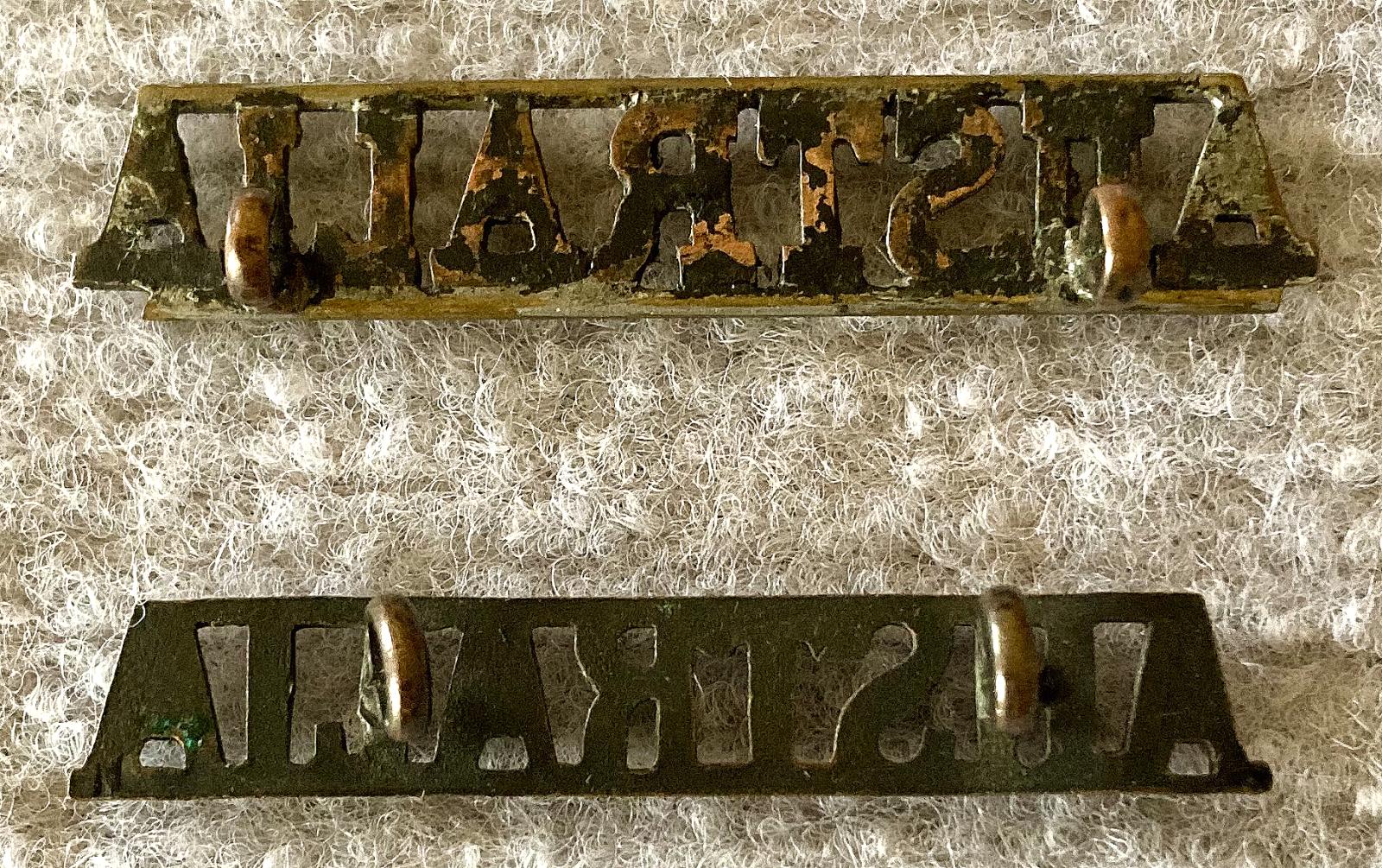 Reverse of straight Australia metal shoulder titles
