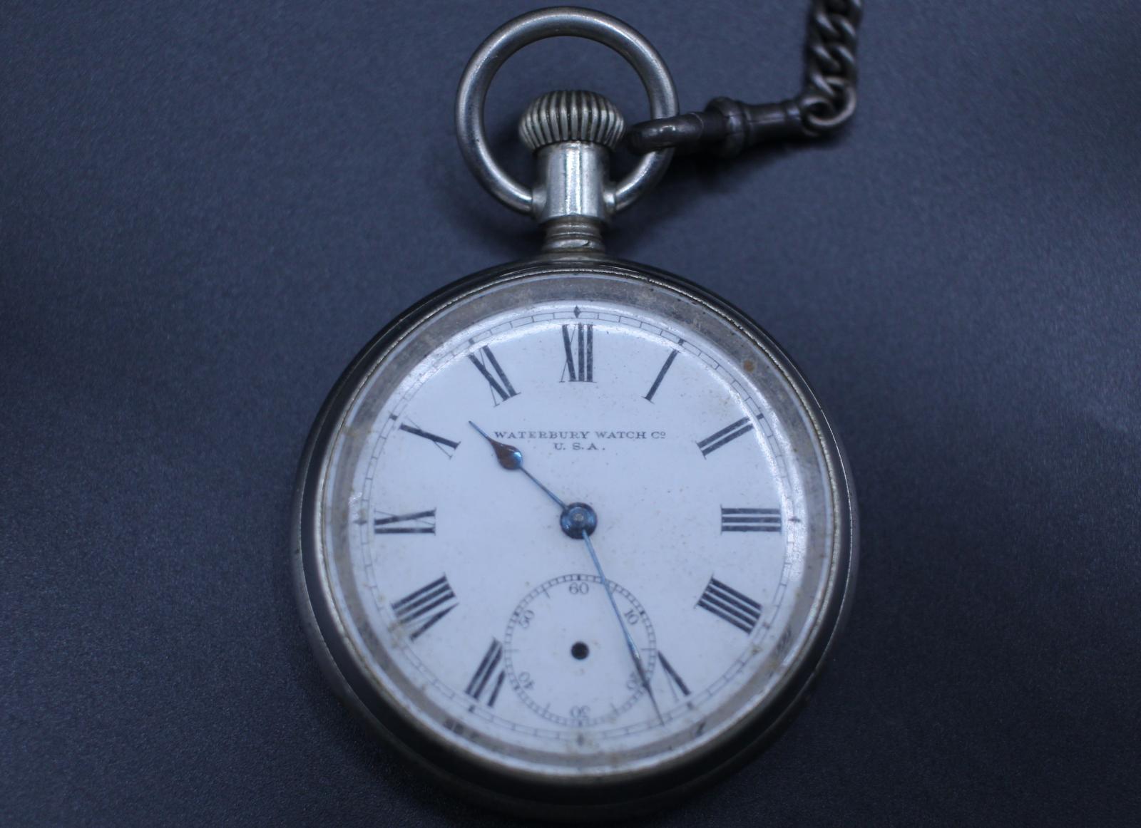A round silver plated pocket watch, with the makers mark "WATERBURY WATCH CO U.S.A." between the centre point and the 12.