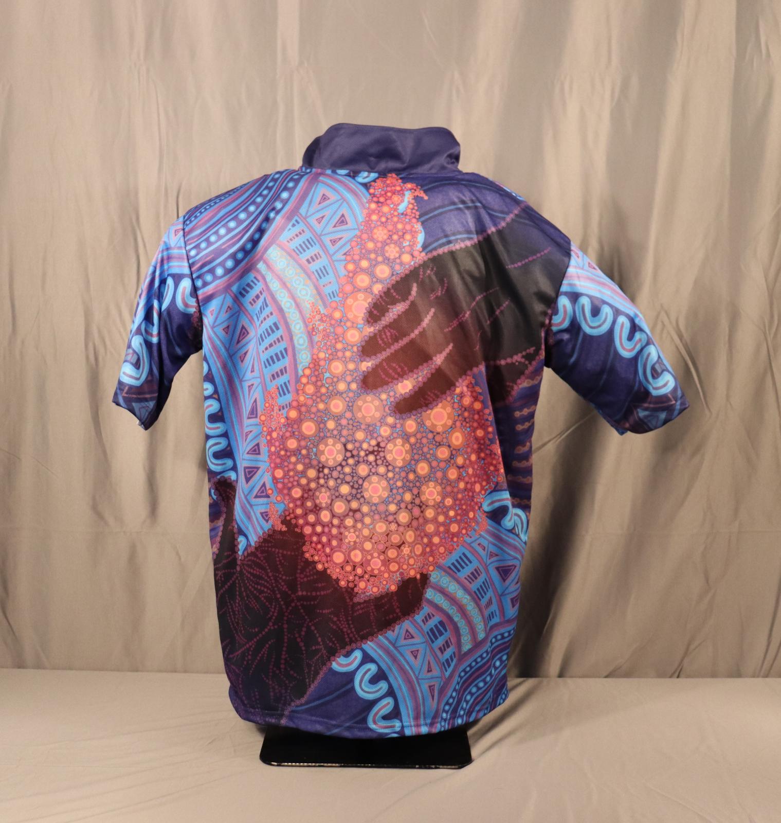 The back side of a short sleeve polo shirt celebrating NAIDOC Week 2024. Mostly blue with Aboriginal art.