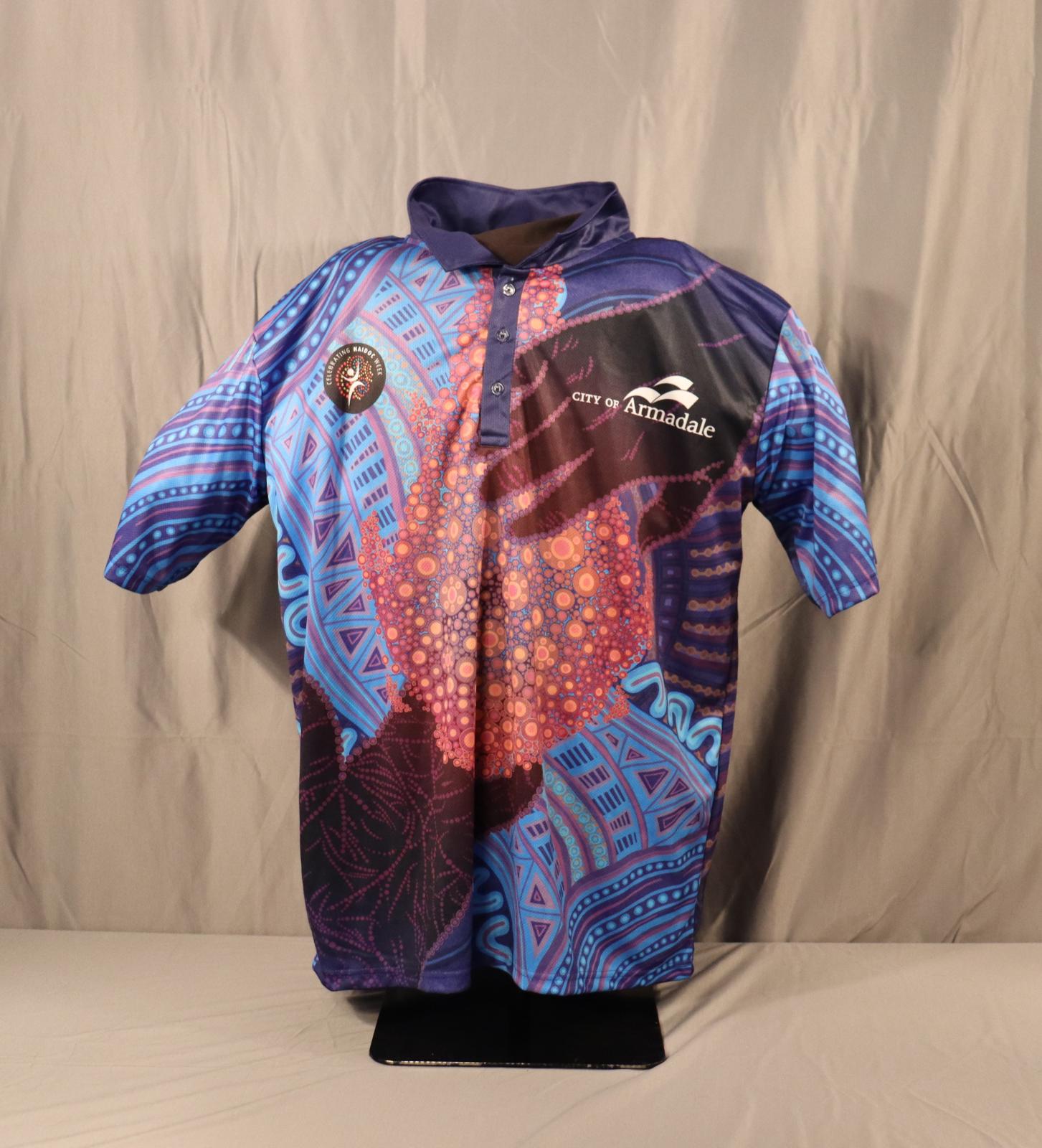 A blue, purple and red polo shirt celebrating NAIDOC week 2024.